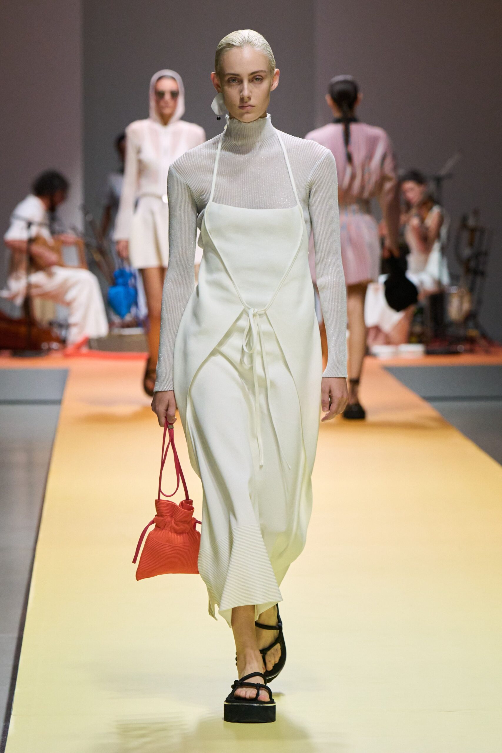 white fitted midi dress with red bag