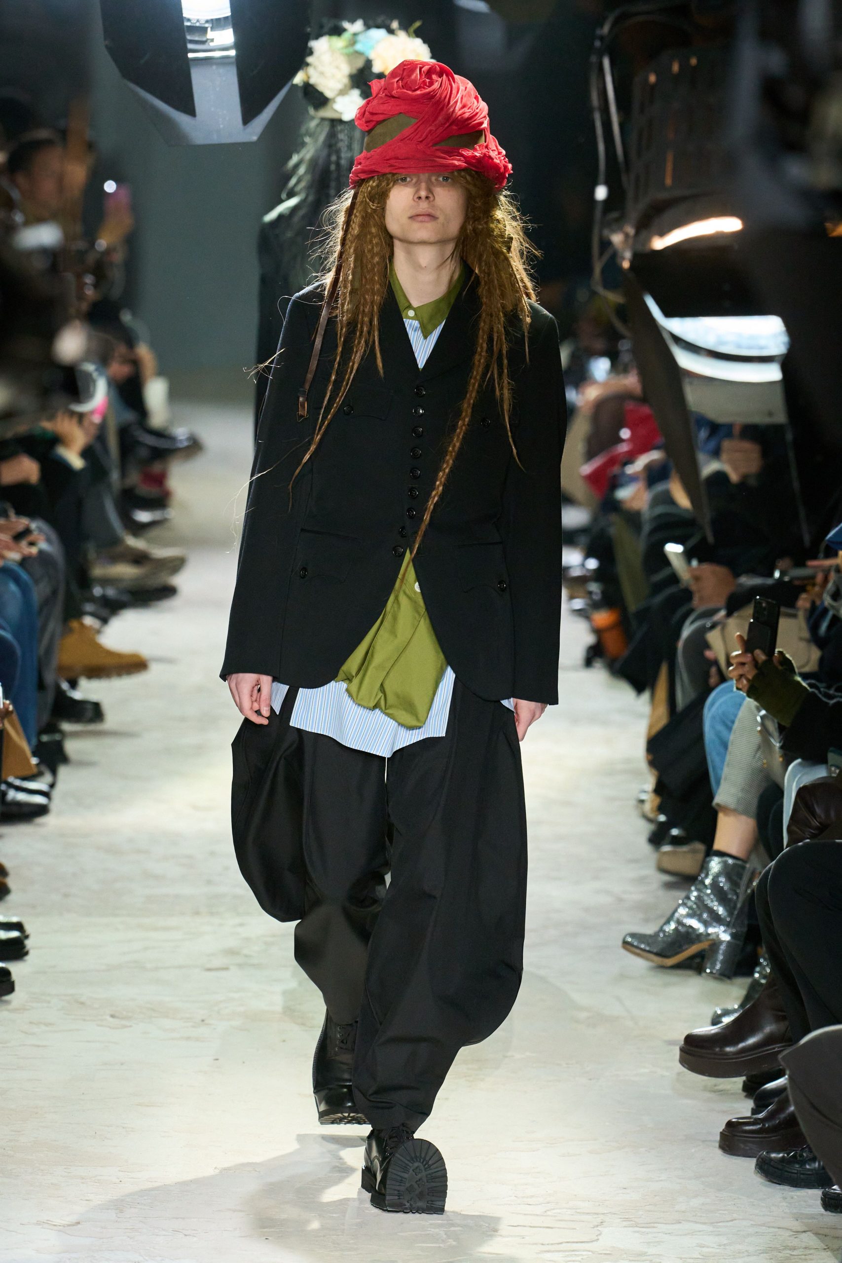 black tailored suit with red hat