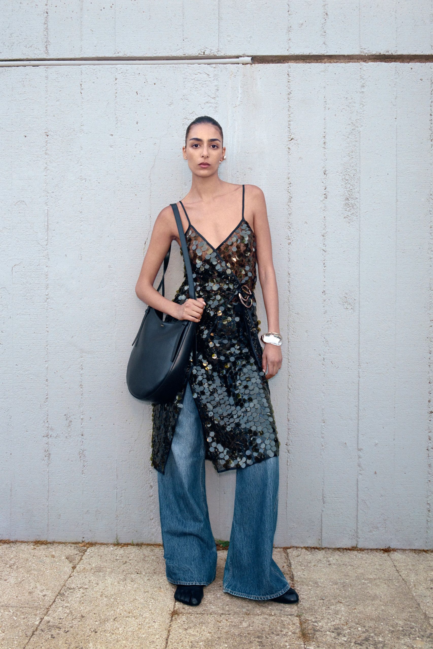 black sequined dress with wide-leg jeans