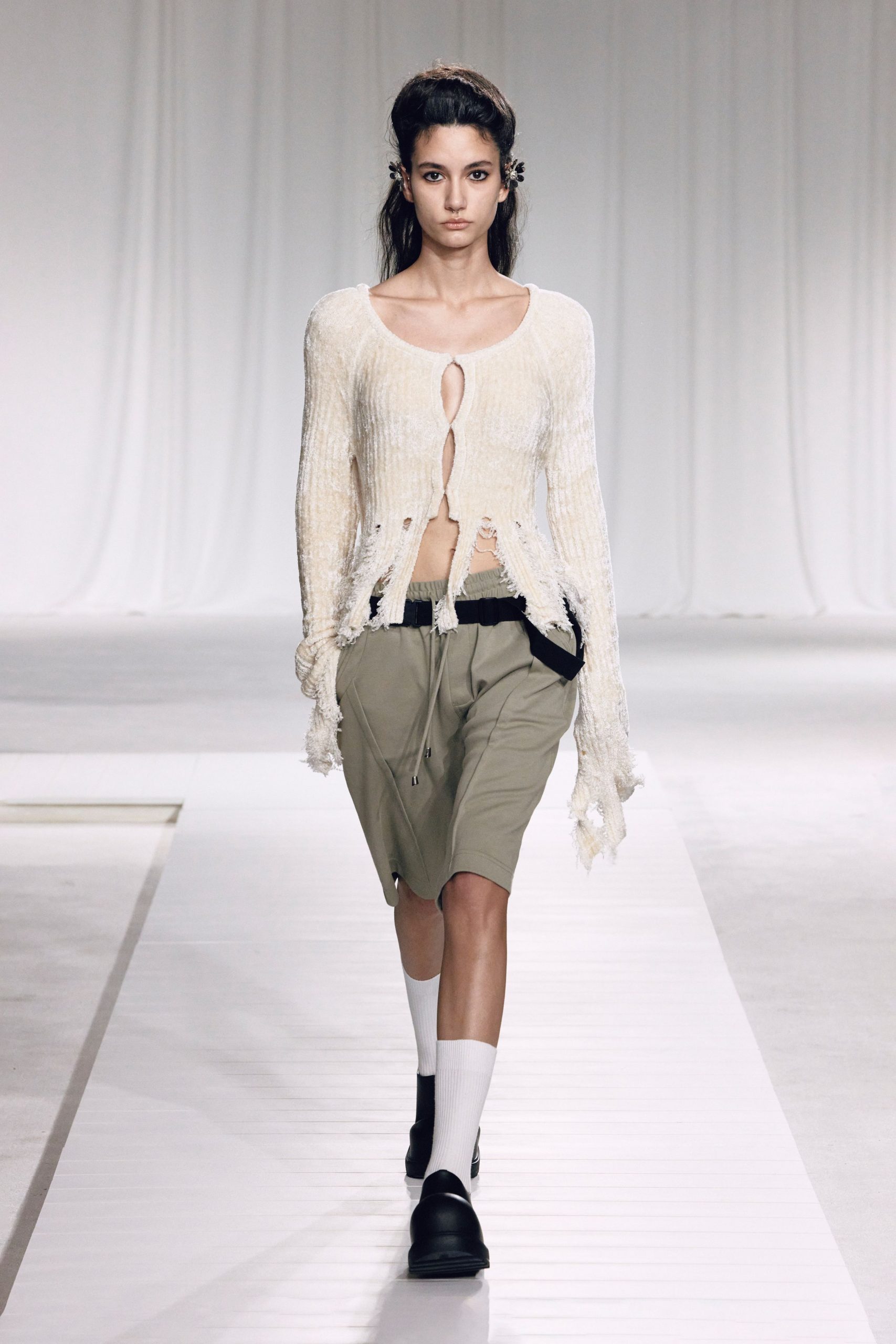 white relaxed top with beige shorts
