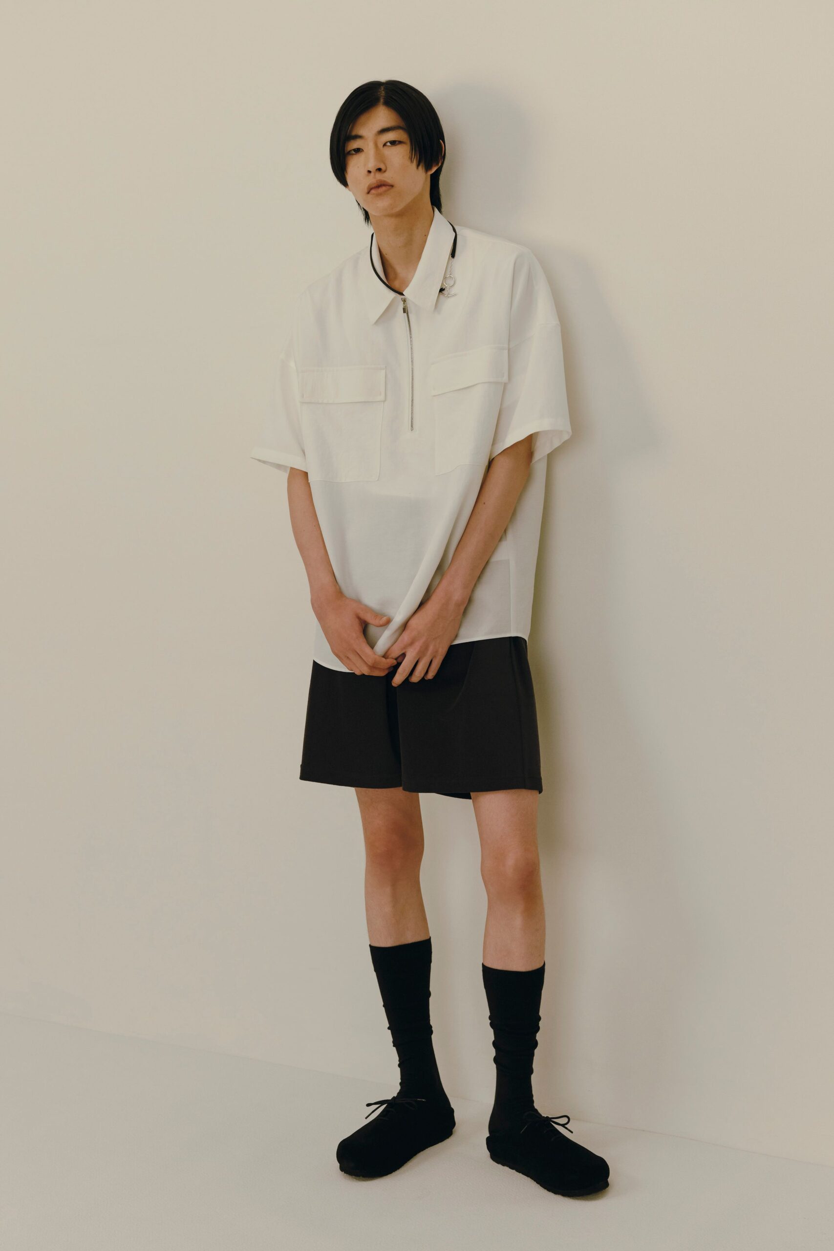 white relaxed shirt with black shorts