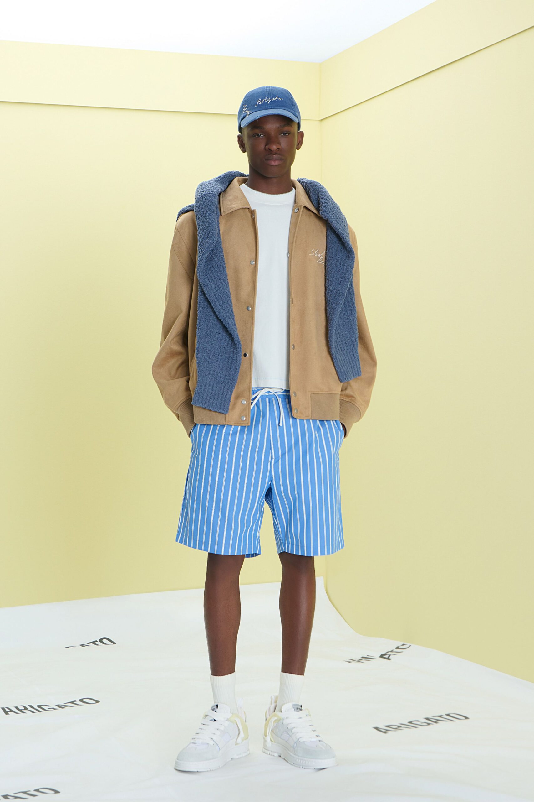 beige jacket white shirt blue shorts