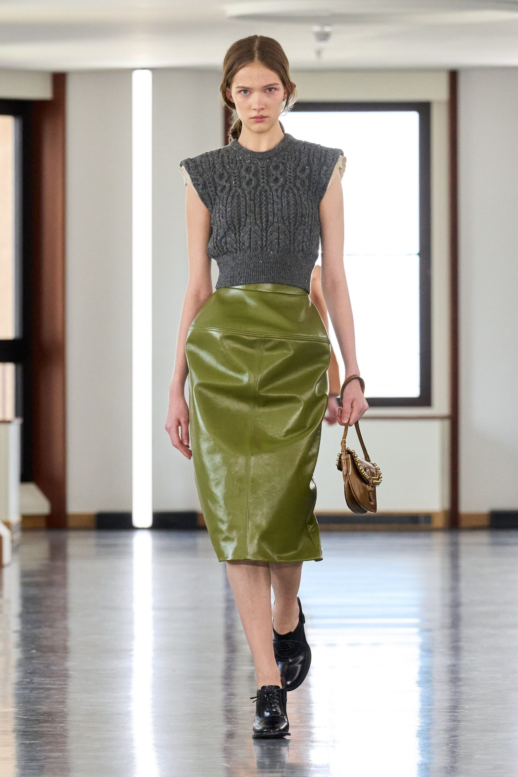 gray wool sleeveless top with green leather skirt