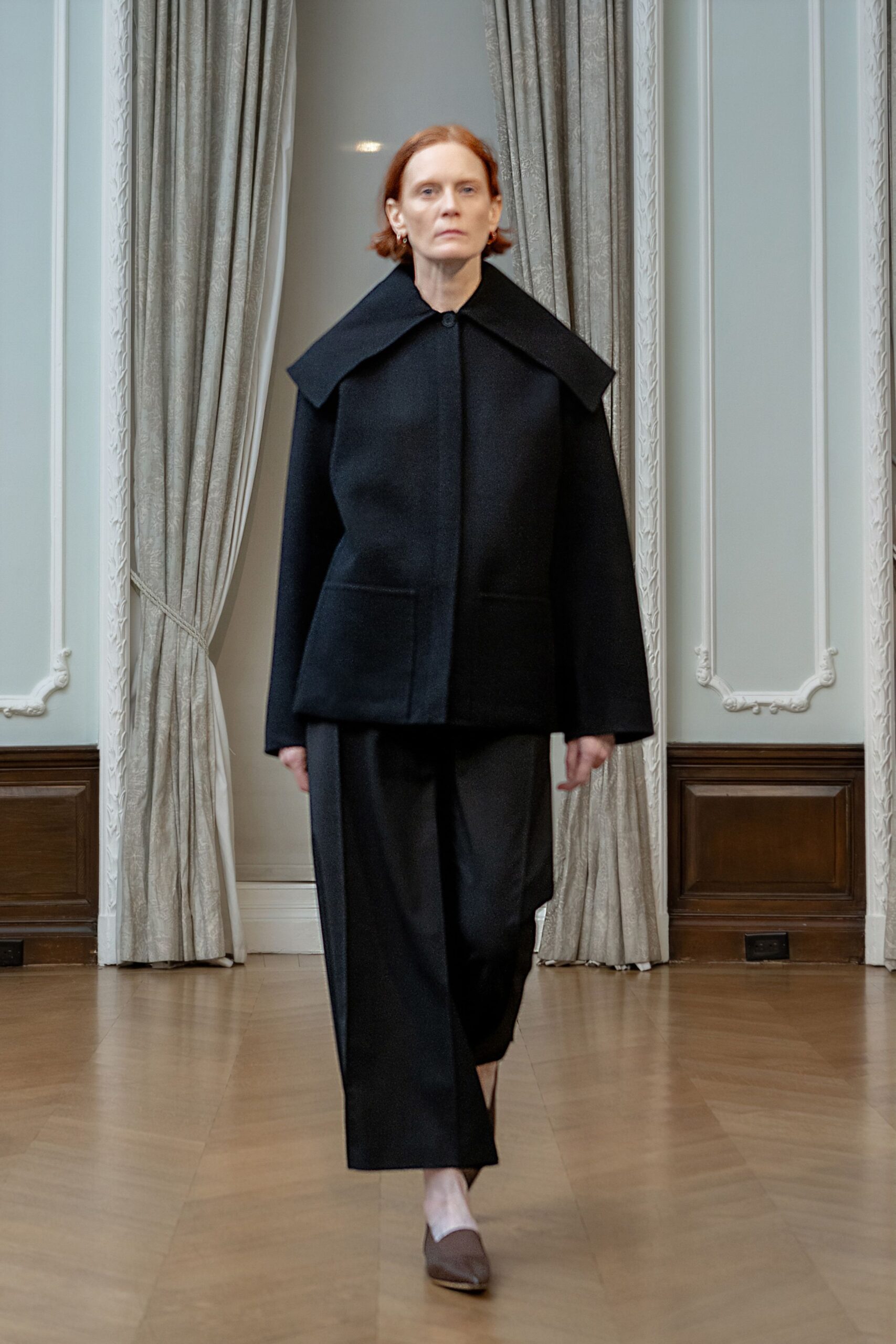 black wool coat with relaxed pants