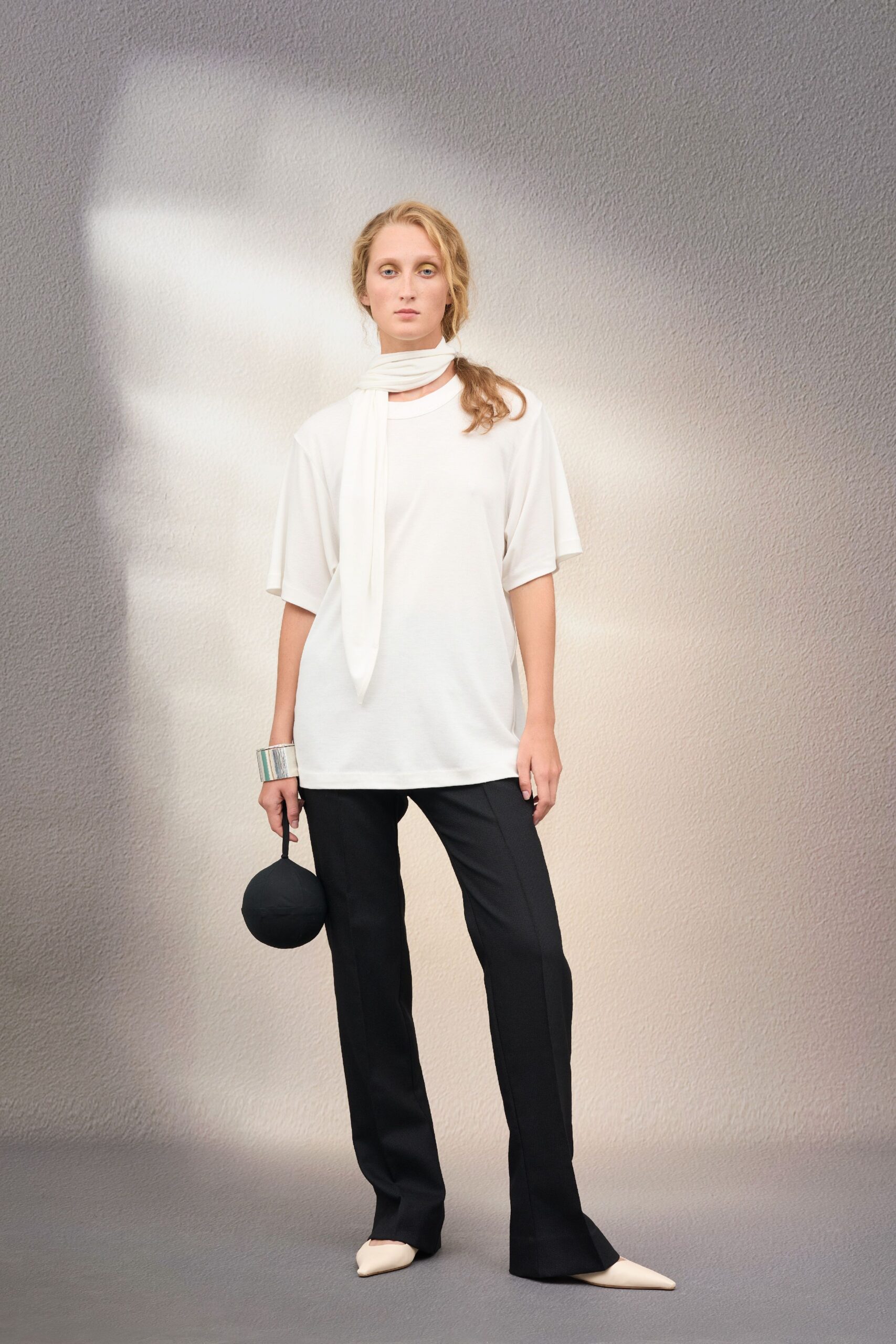 white relaxed top with black pants