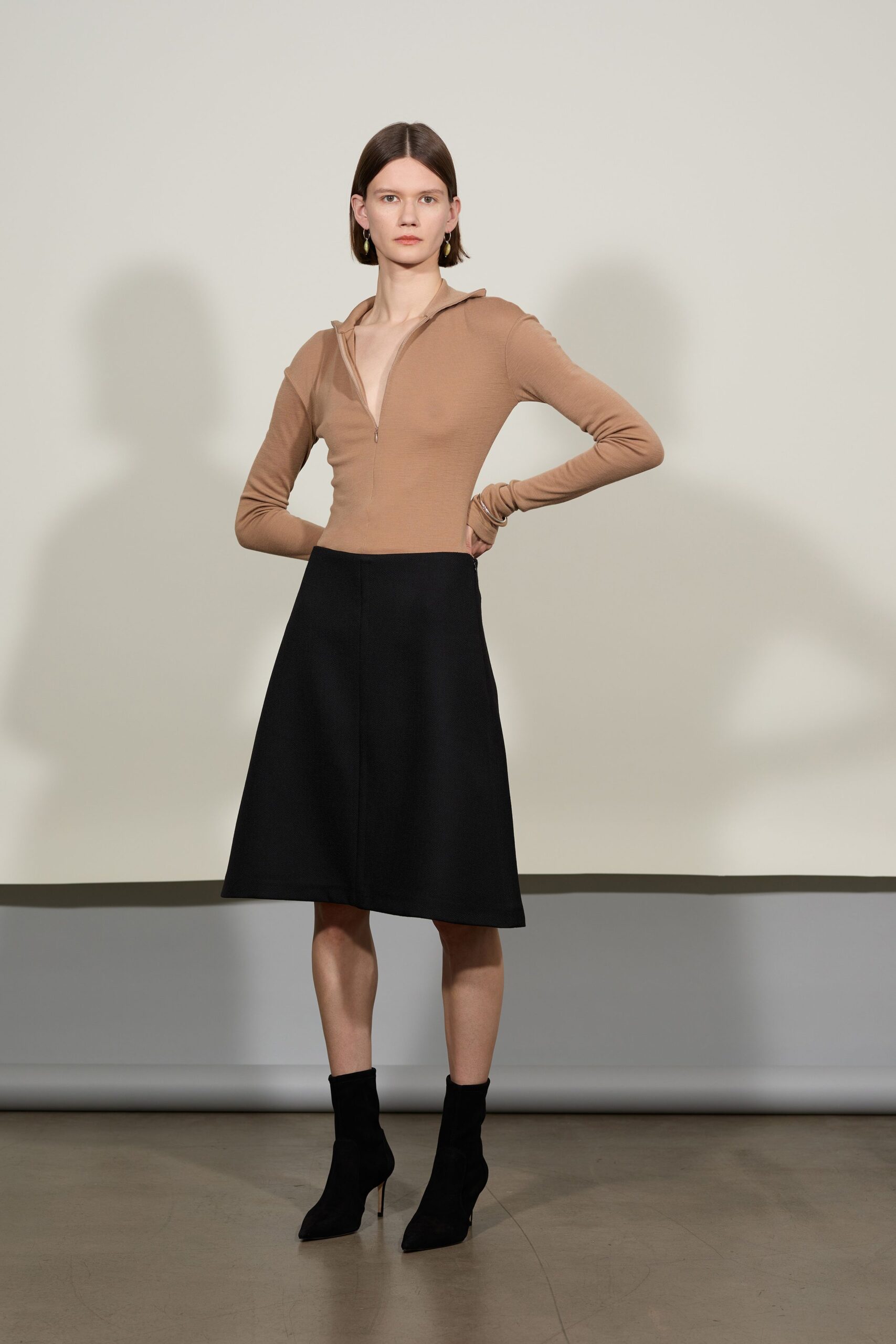 beige fitted top black midi skirt