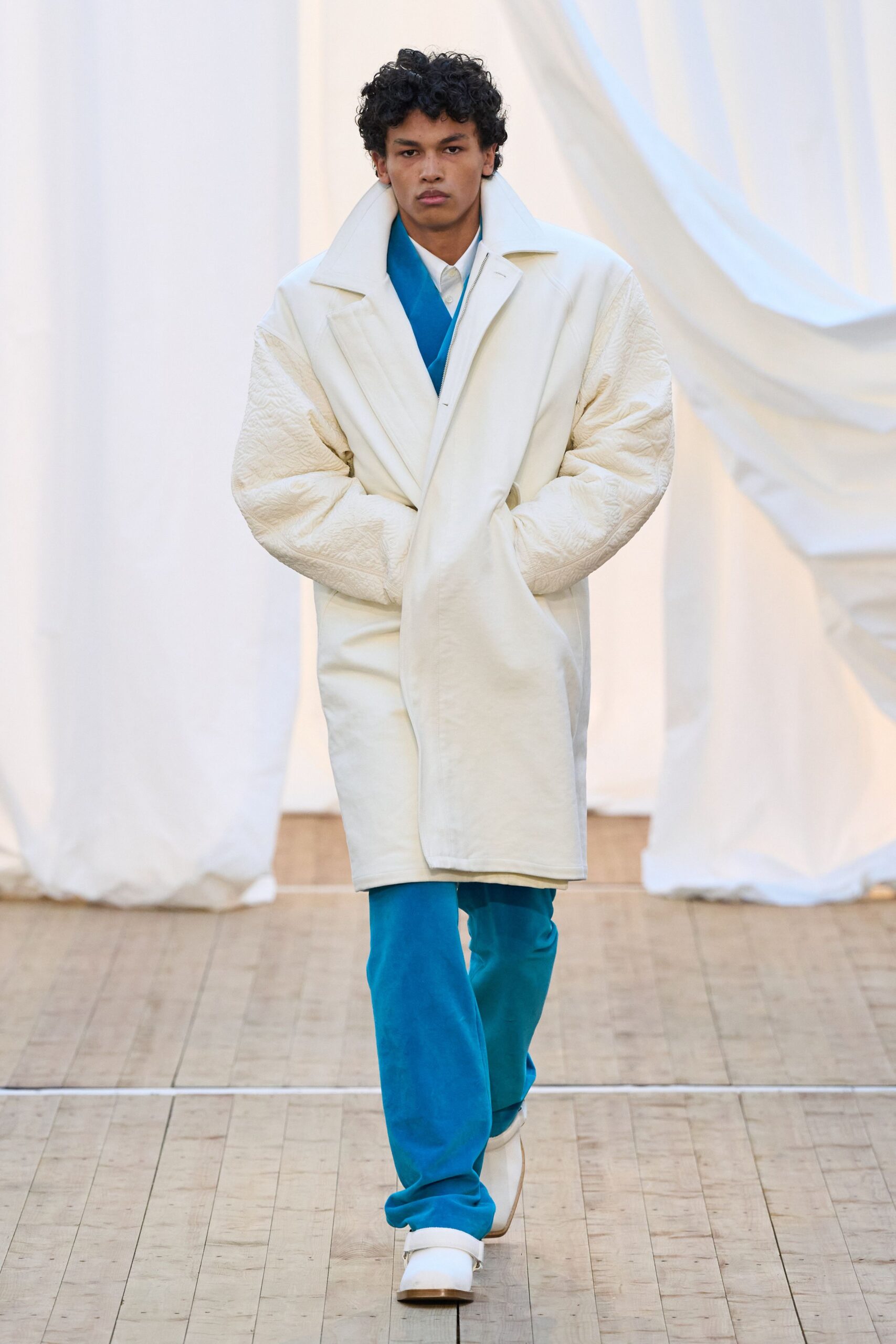 white coat blue suit white shoes