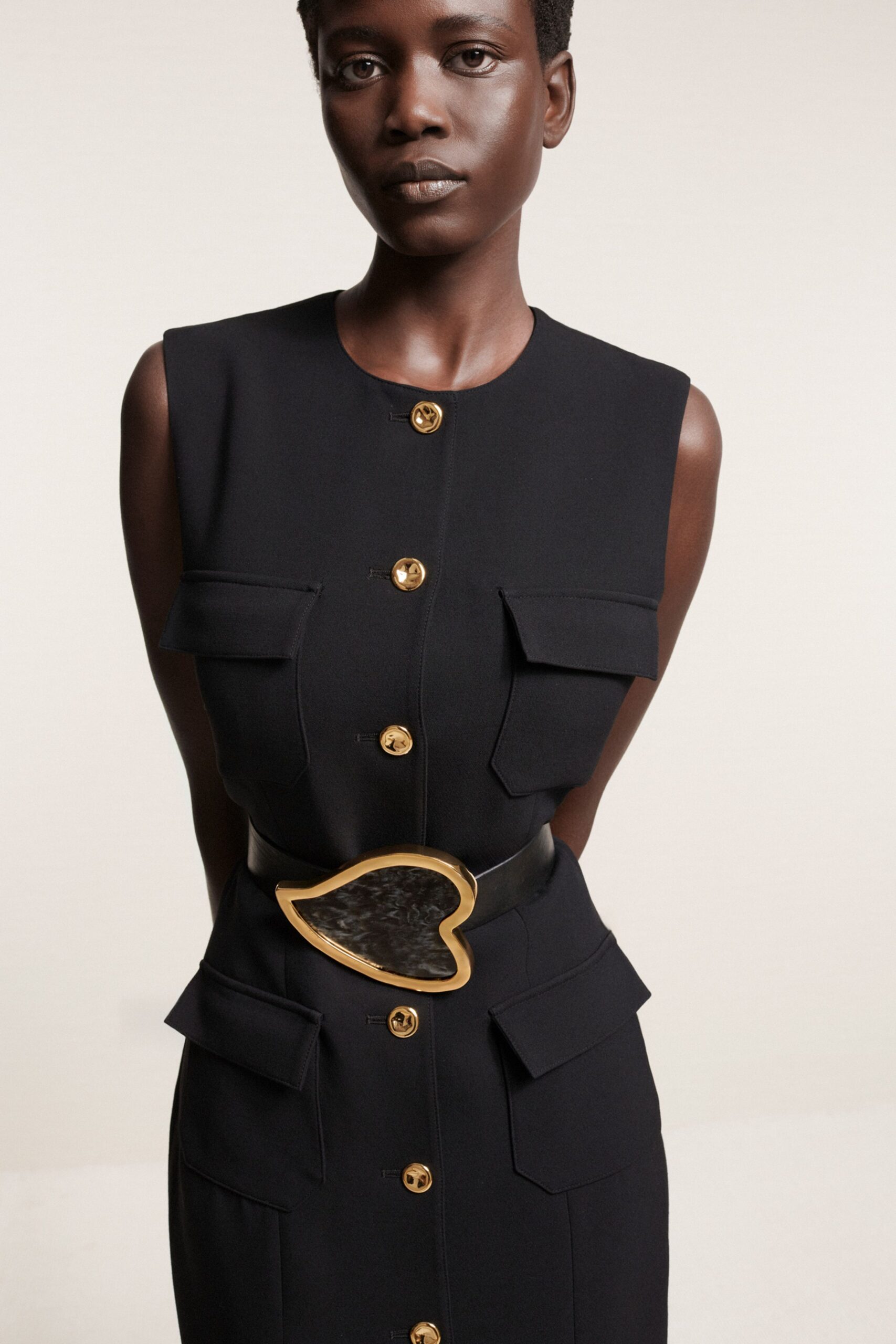 black fitted sleeveless dress with belt