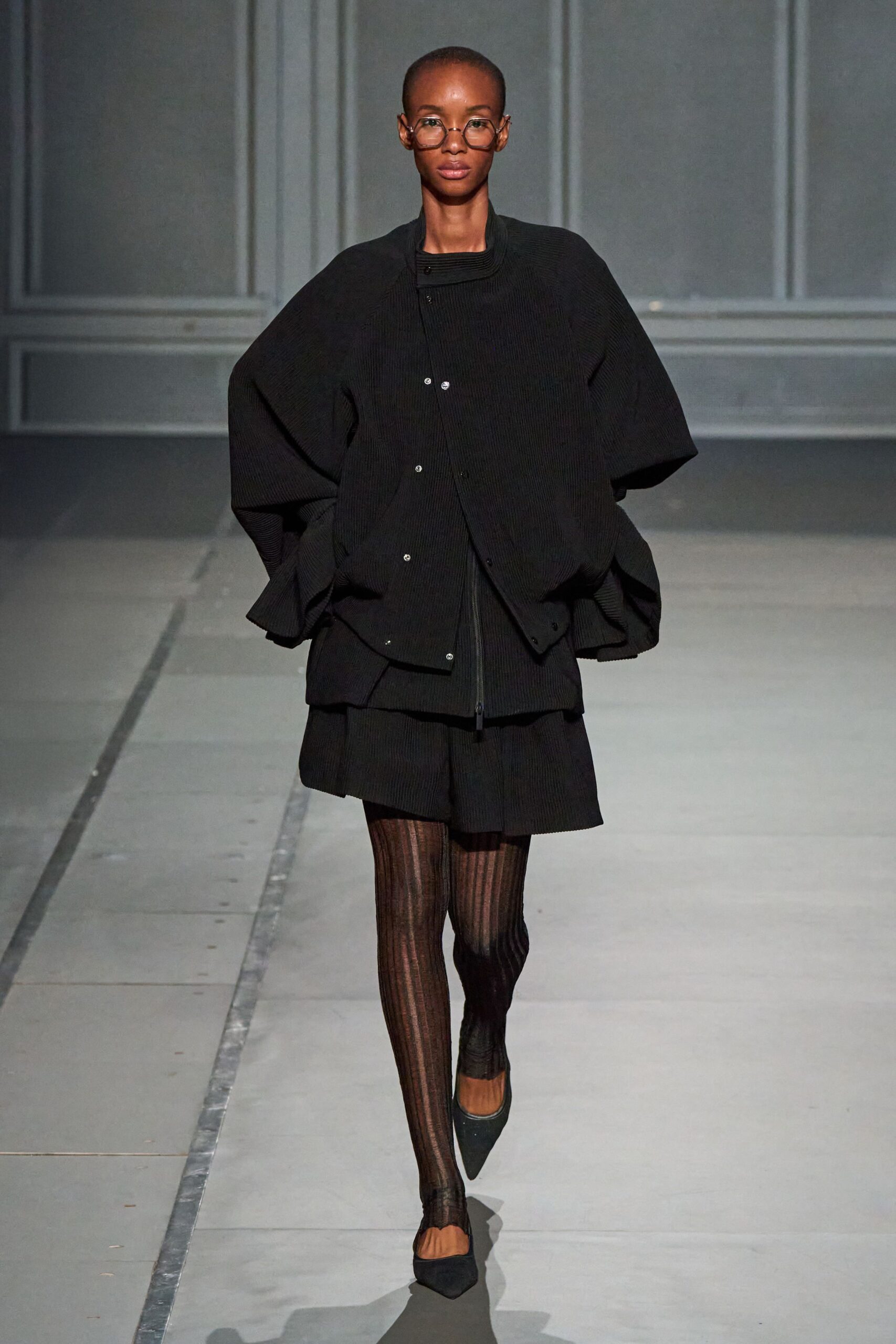 oversized black jacket with pleated skirt