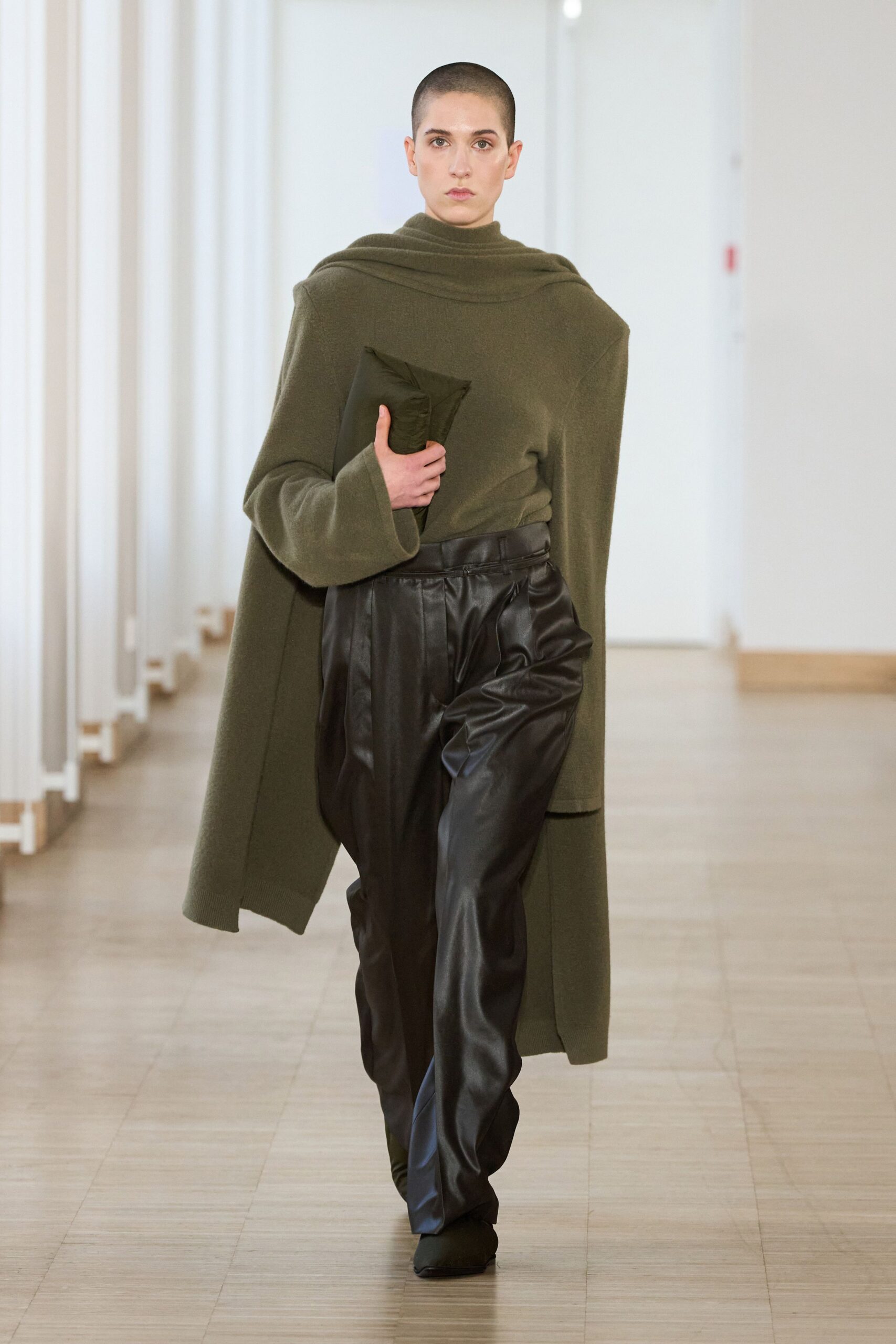 green wool cape and black leather pants