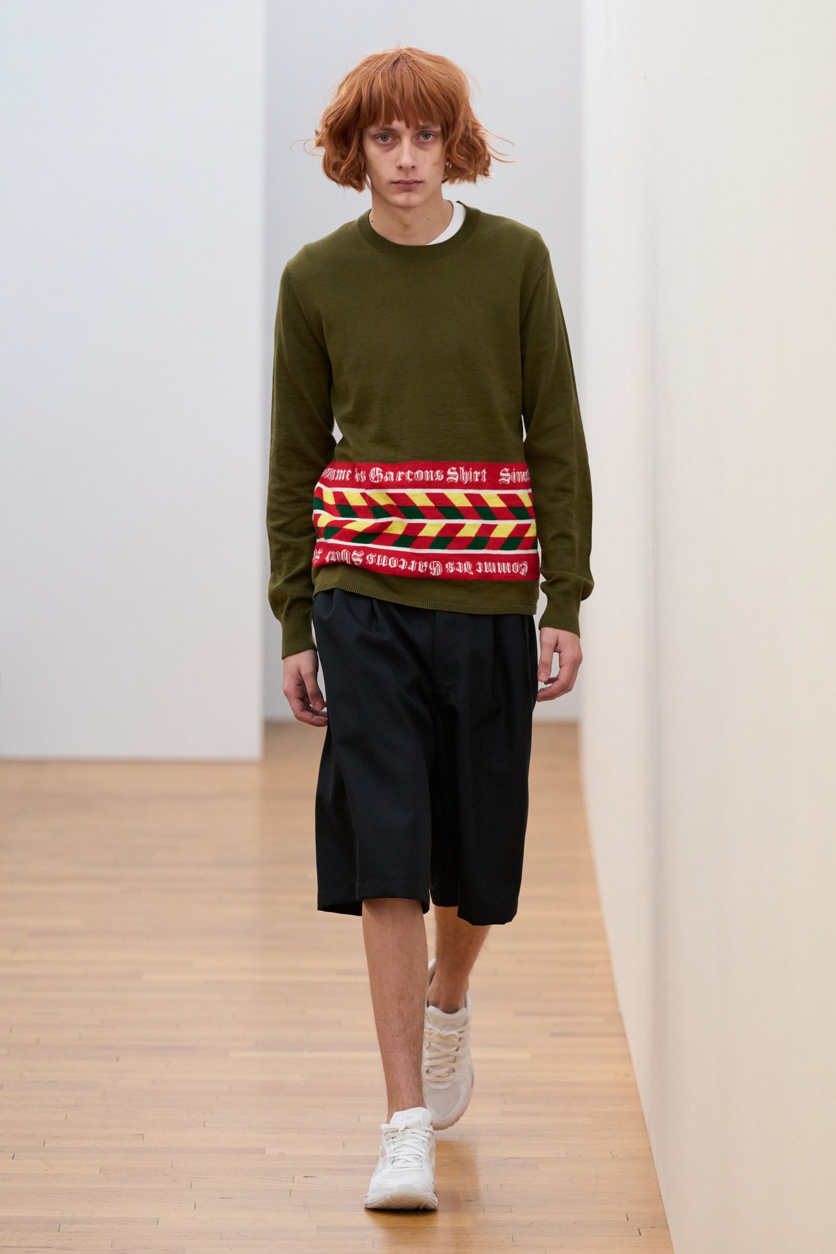 green relaxed sweater with black shorts