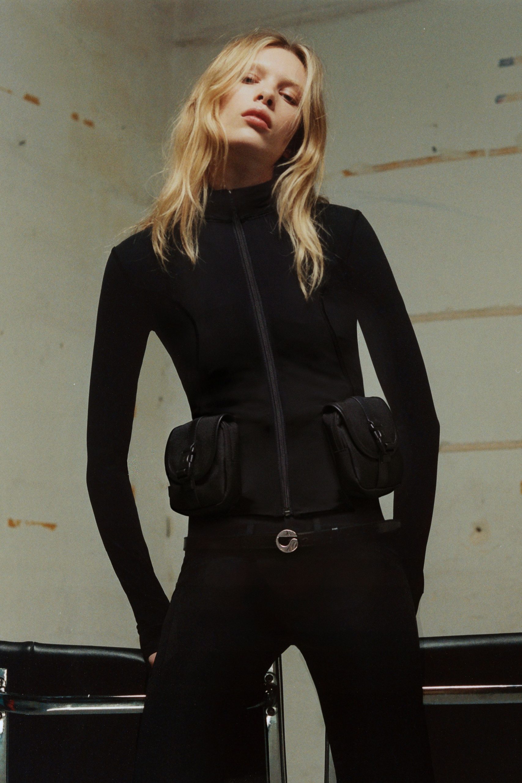black neoprene long-sleeve high-neck fitted zippered pockets top
