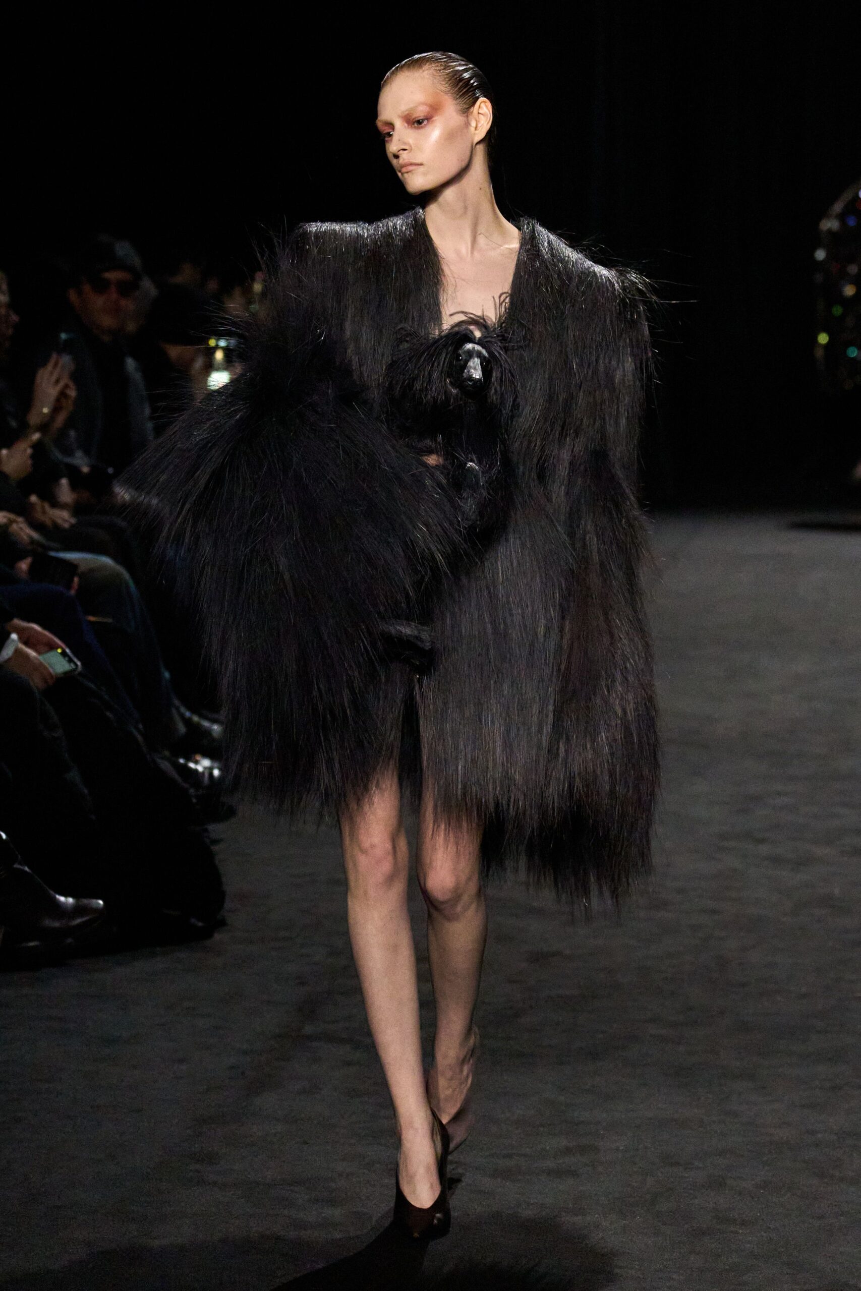 black oversized fur coat and fitted dress