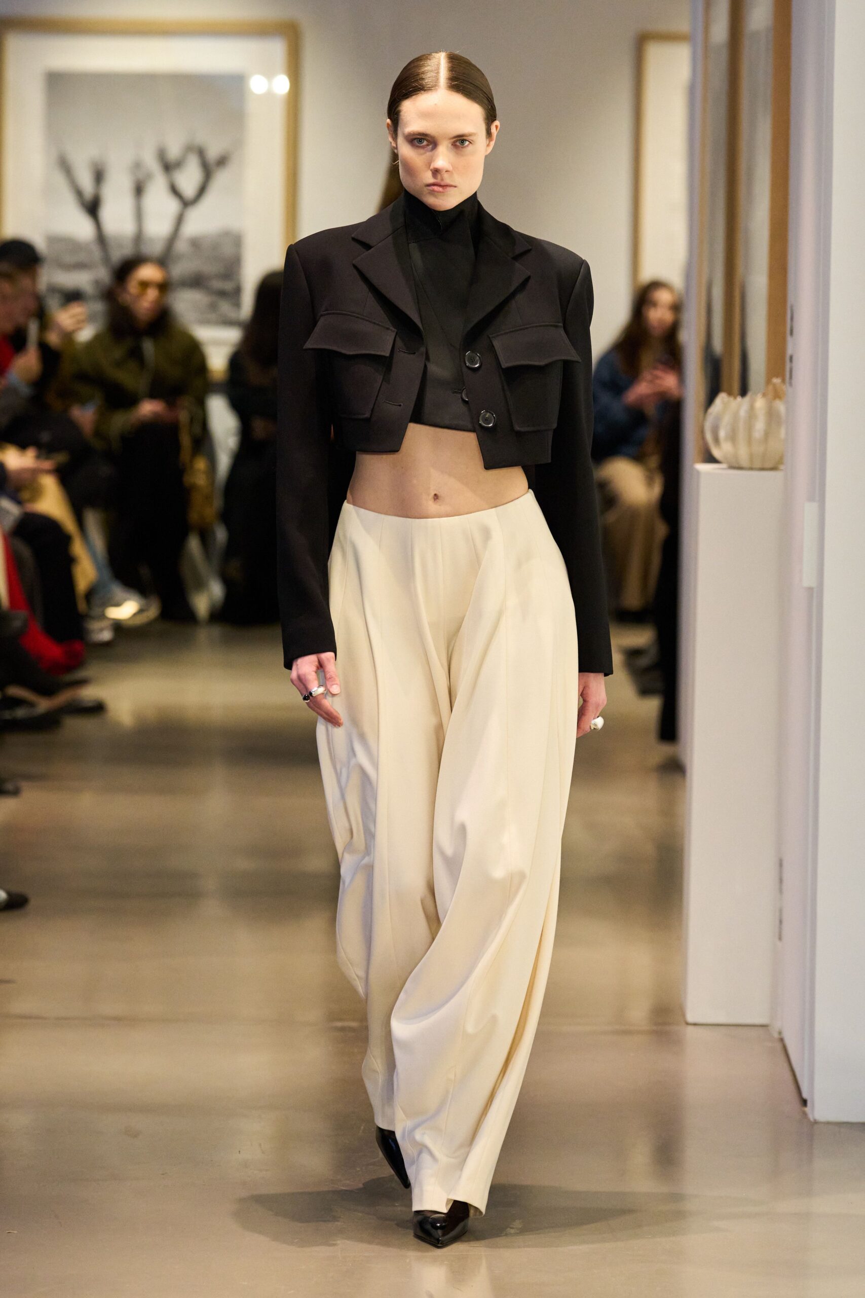 black blazer gray top beige pants