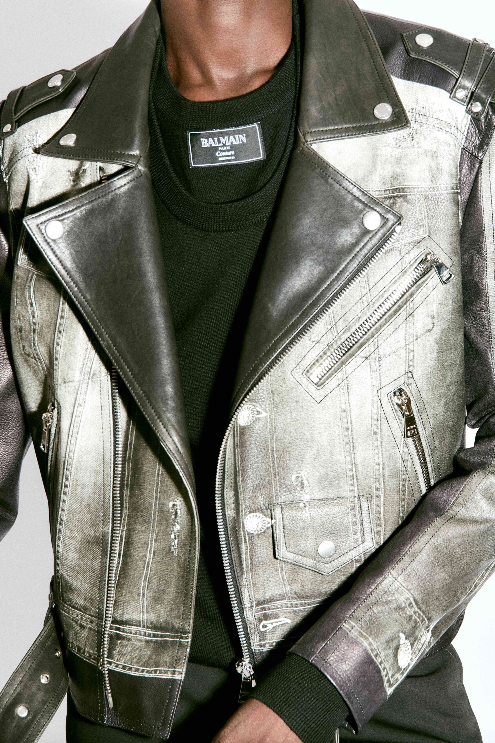 fitted black leather jacket and relaxed black sweater