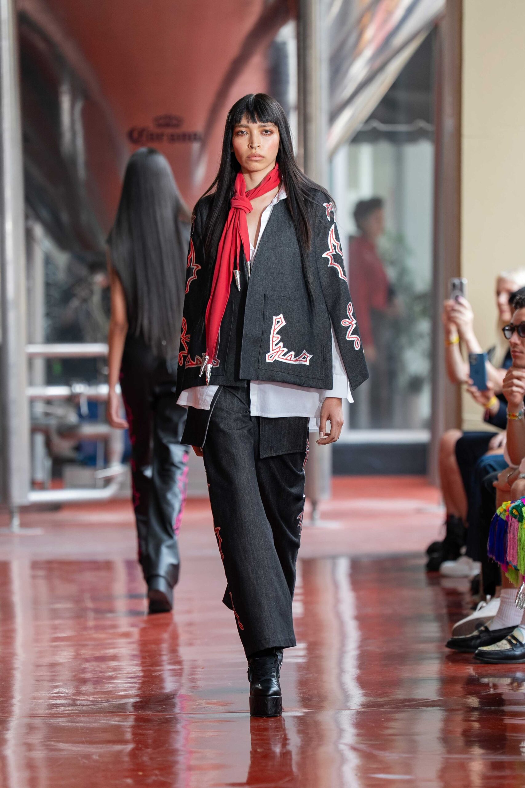 black embroidered jacket with red scarf