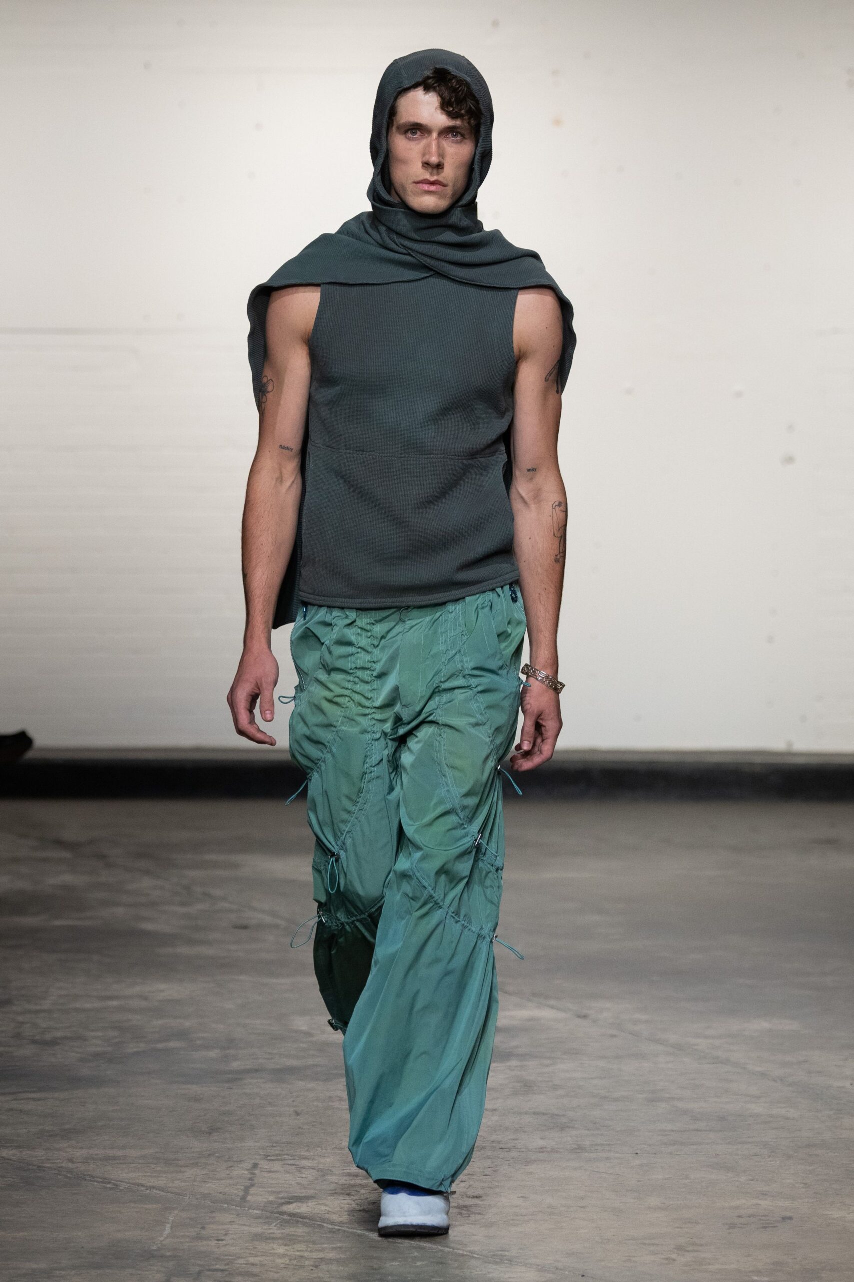 gray hooded top with teal cargo pants