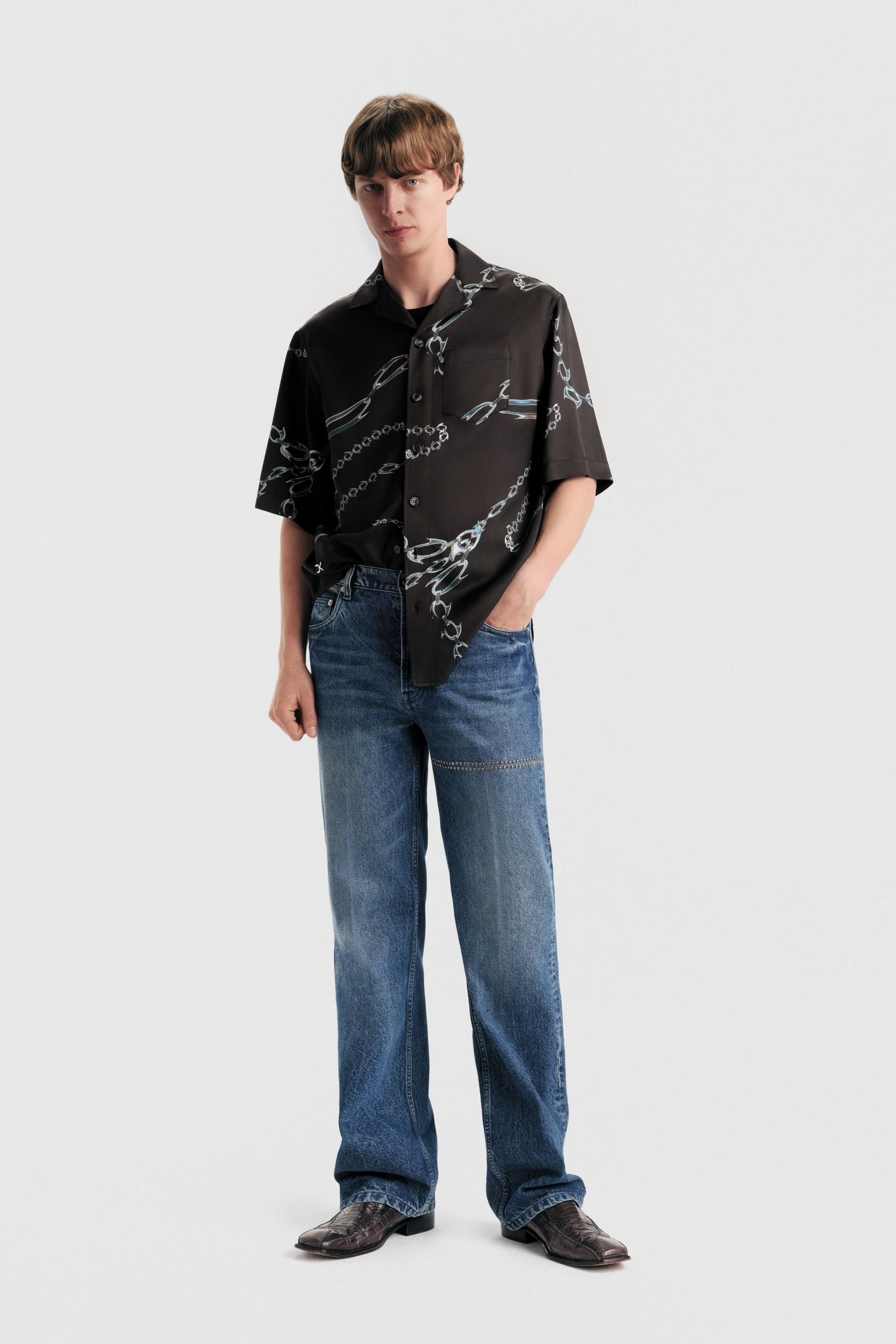 black printed short-sleeve shirt with blue jeans