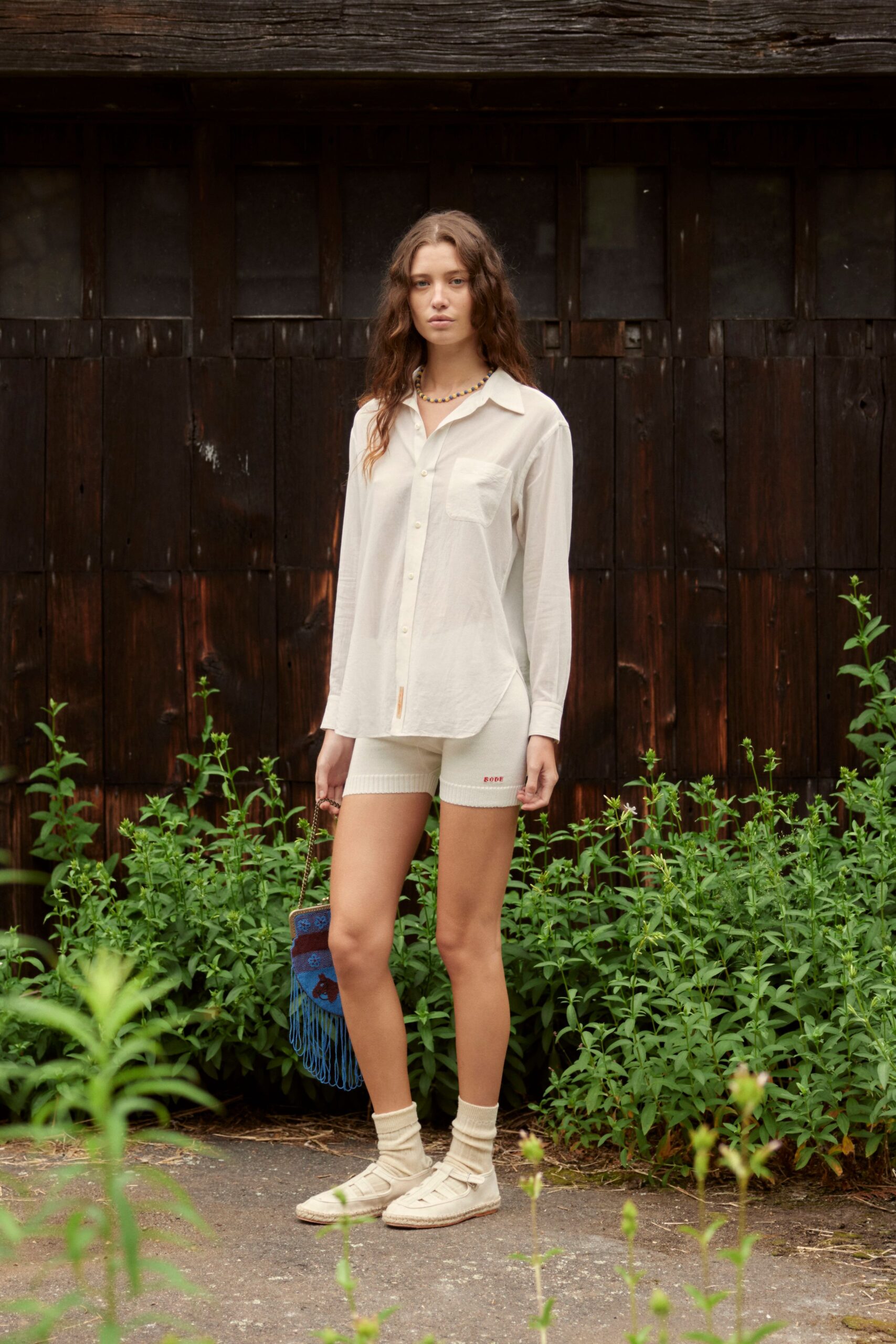 white relaxed shirt with beige shorts