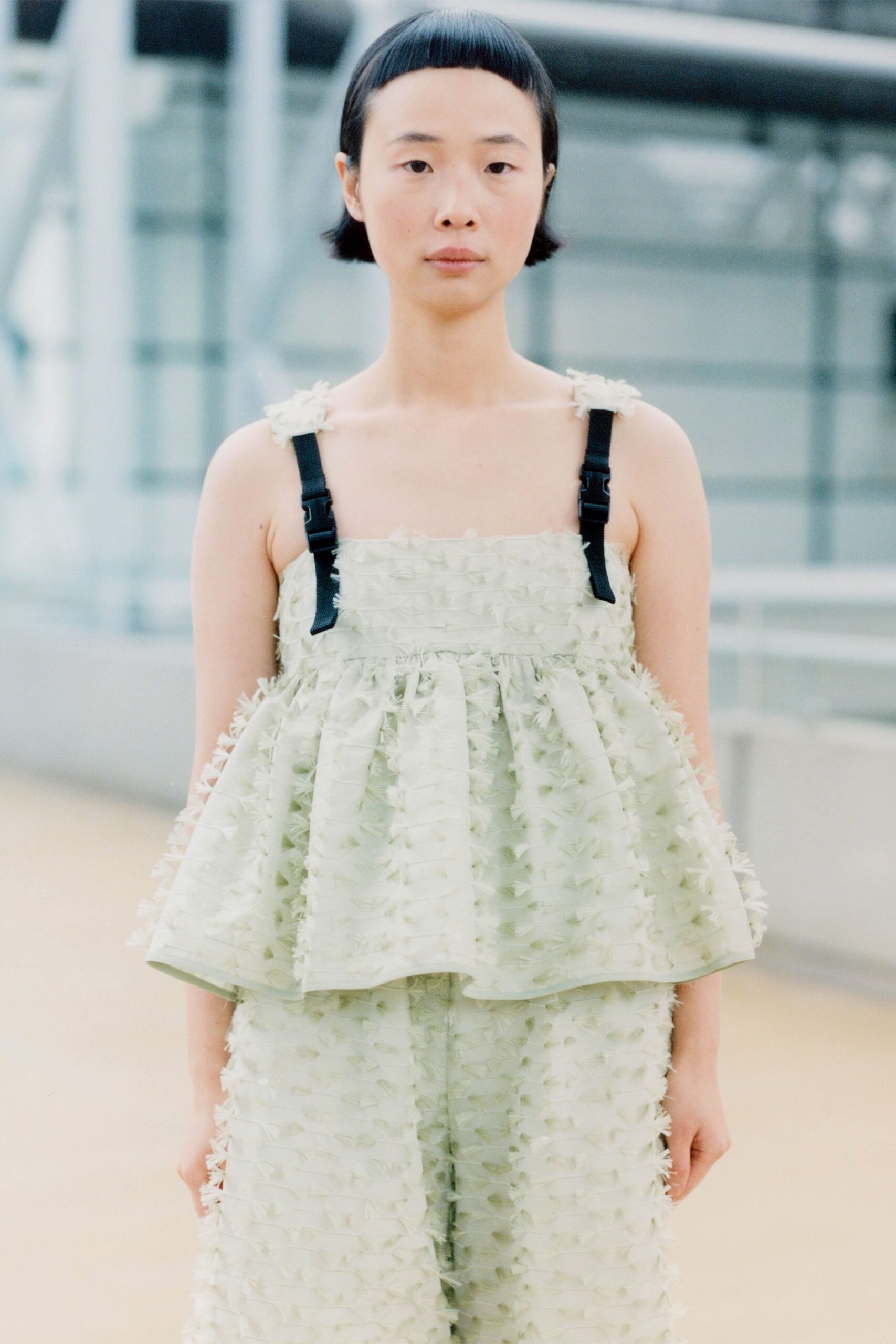 green ruffled top and wide-leg pants