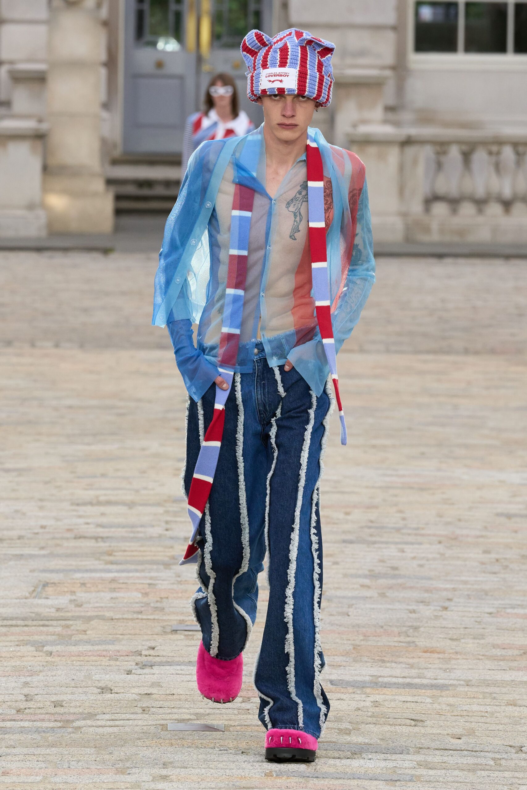 sheer blue top with flared jeans