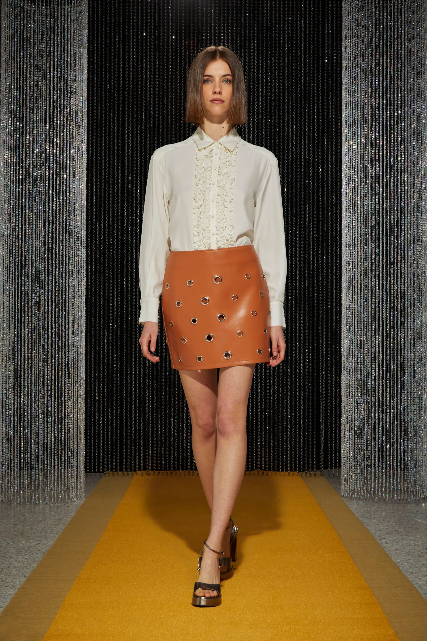 white ruffled shirt brown leather skirt