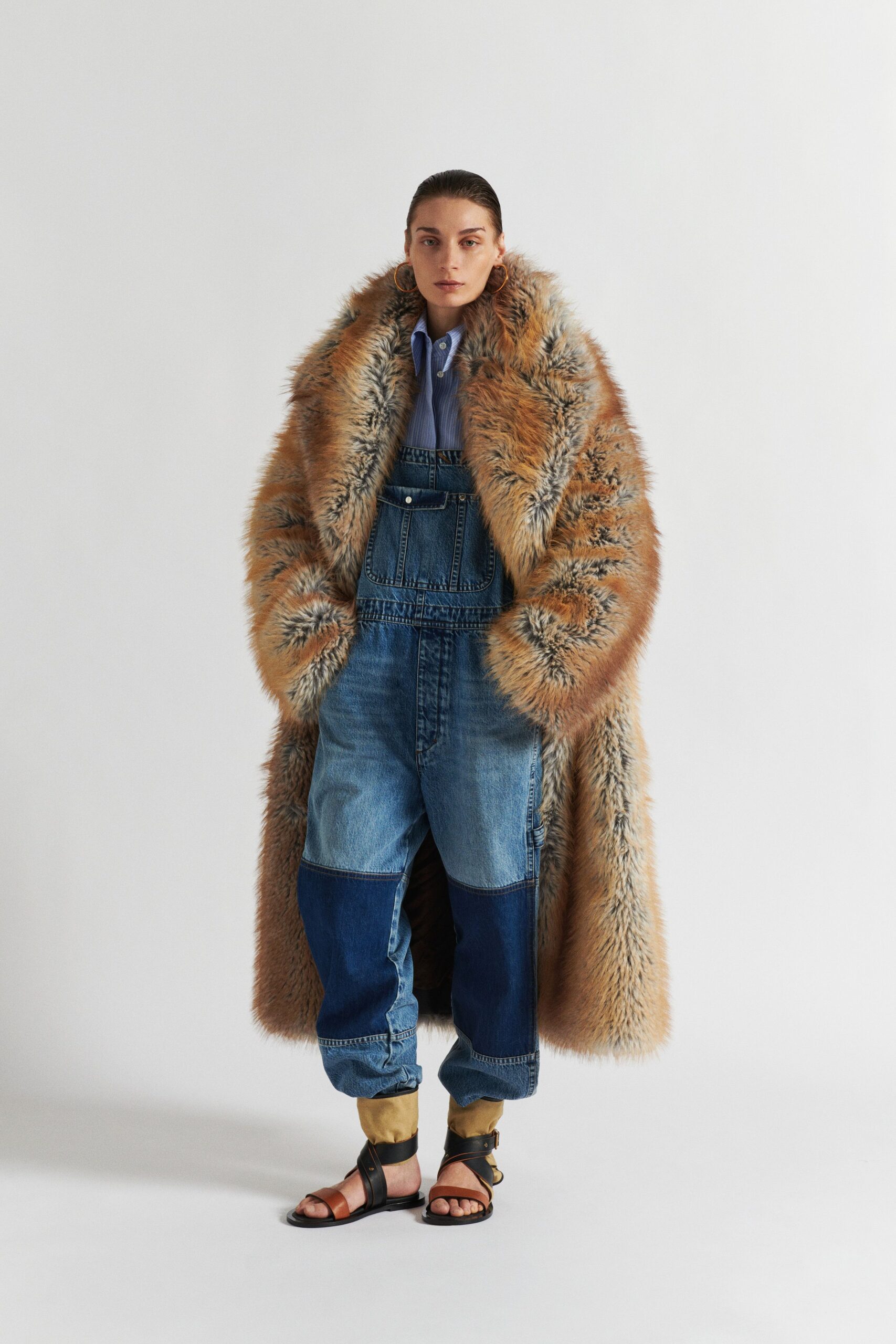 brown fur coat with denim overalls
