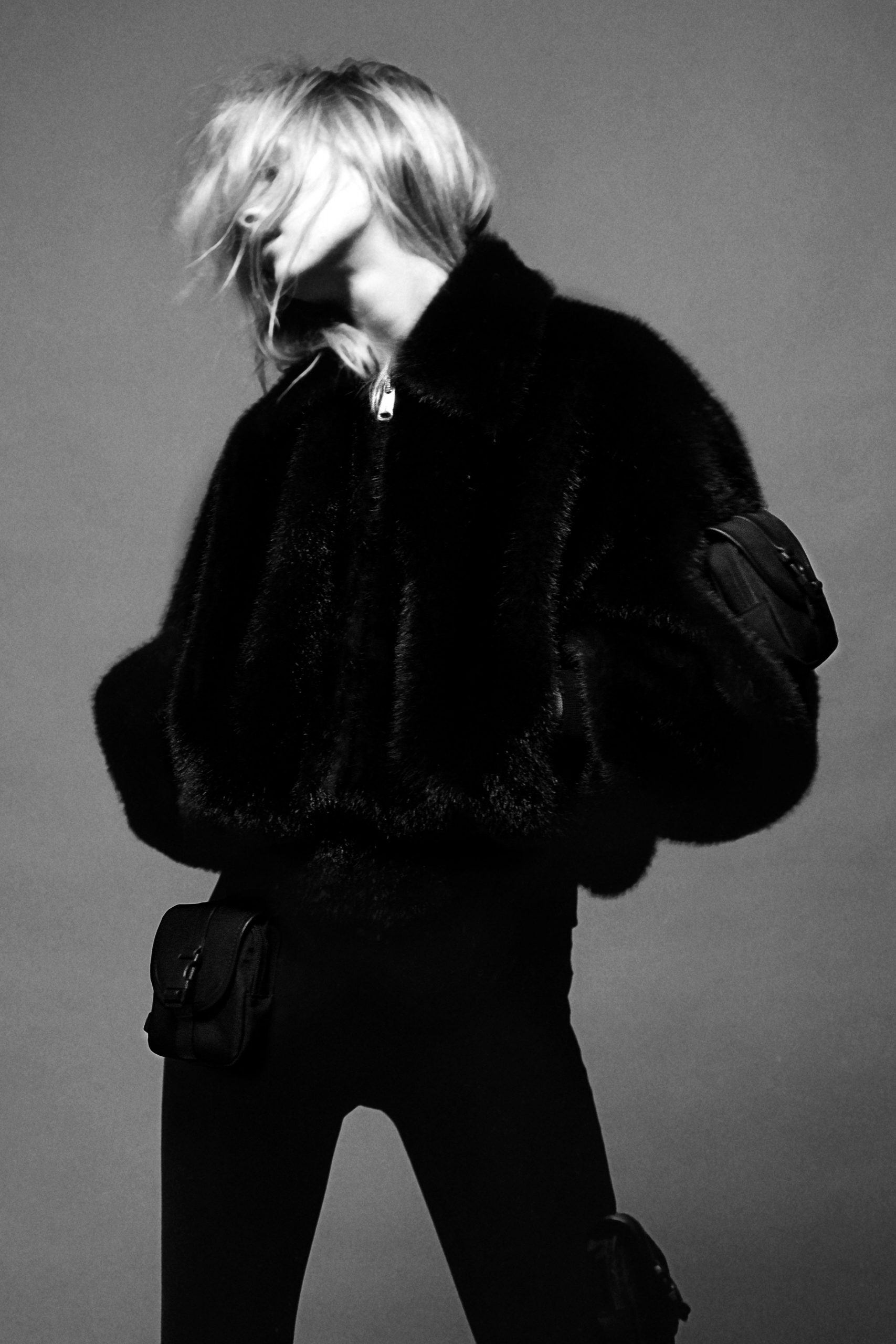 black faux-fur jacket with fitted pants