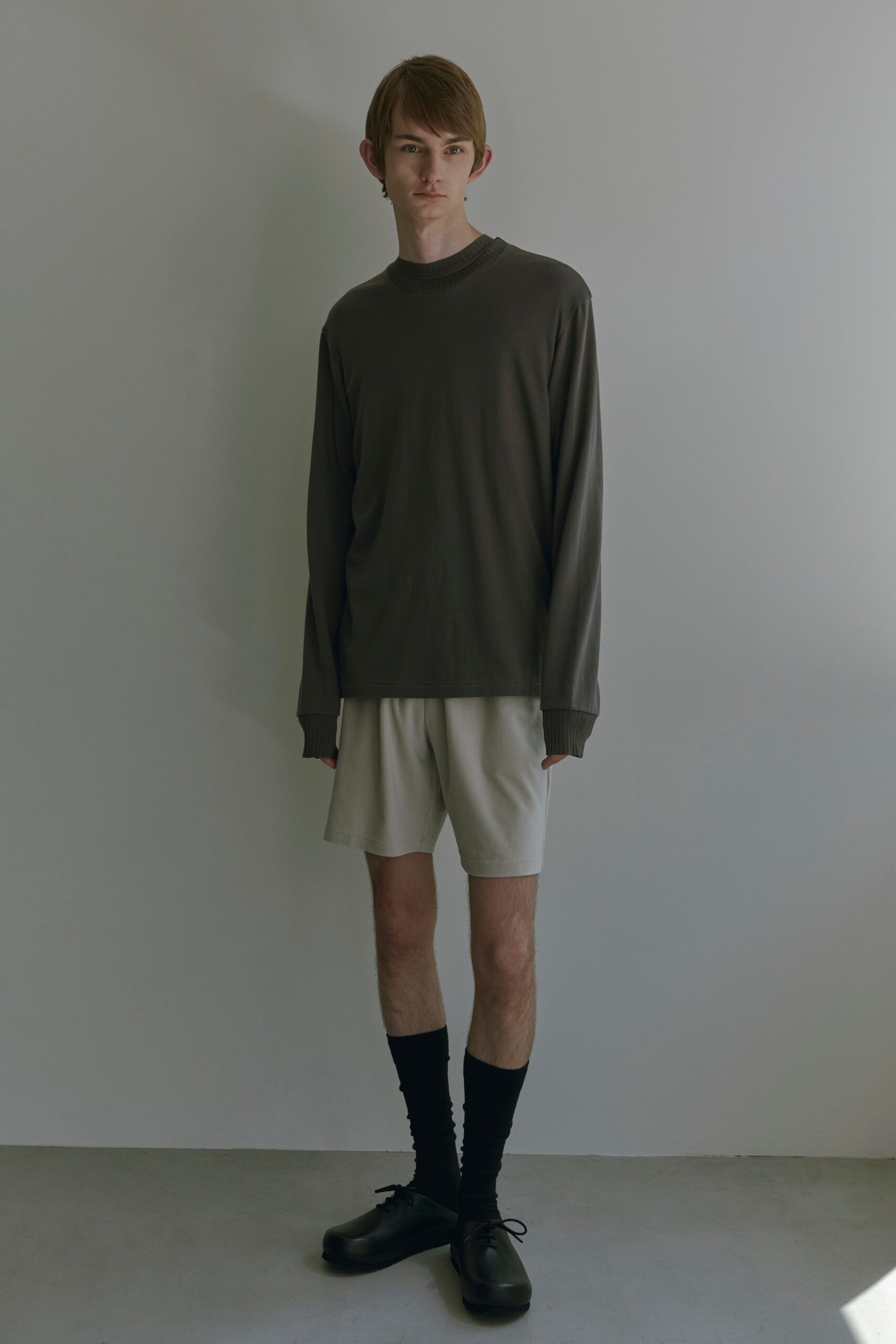 gray relaxed long-sleeve top with beige shorts