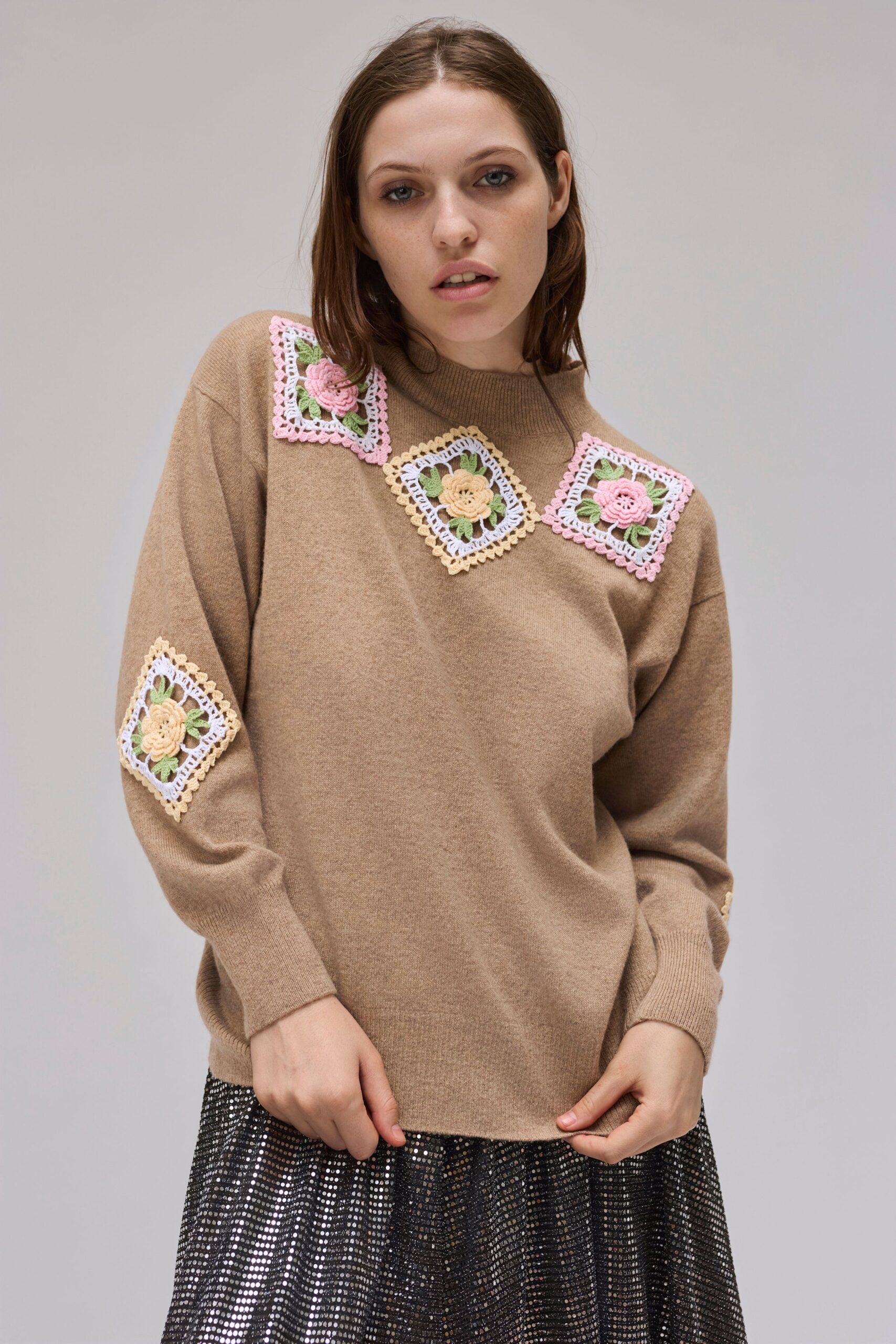 brown wool relaxed sweater and black pleated skirt