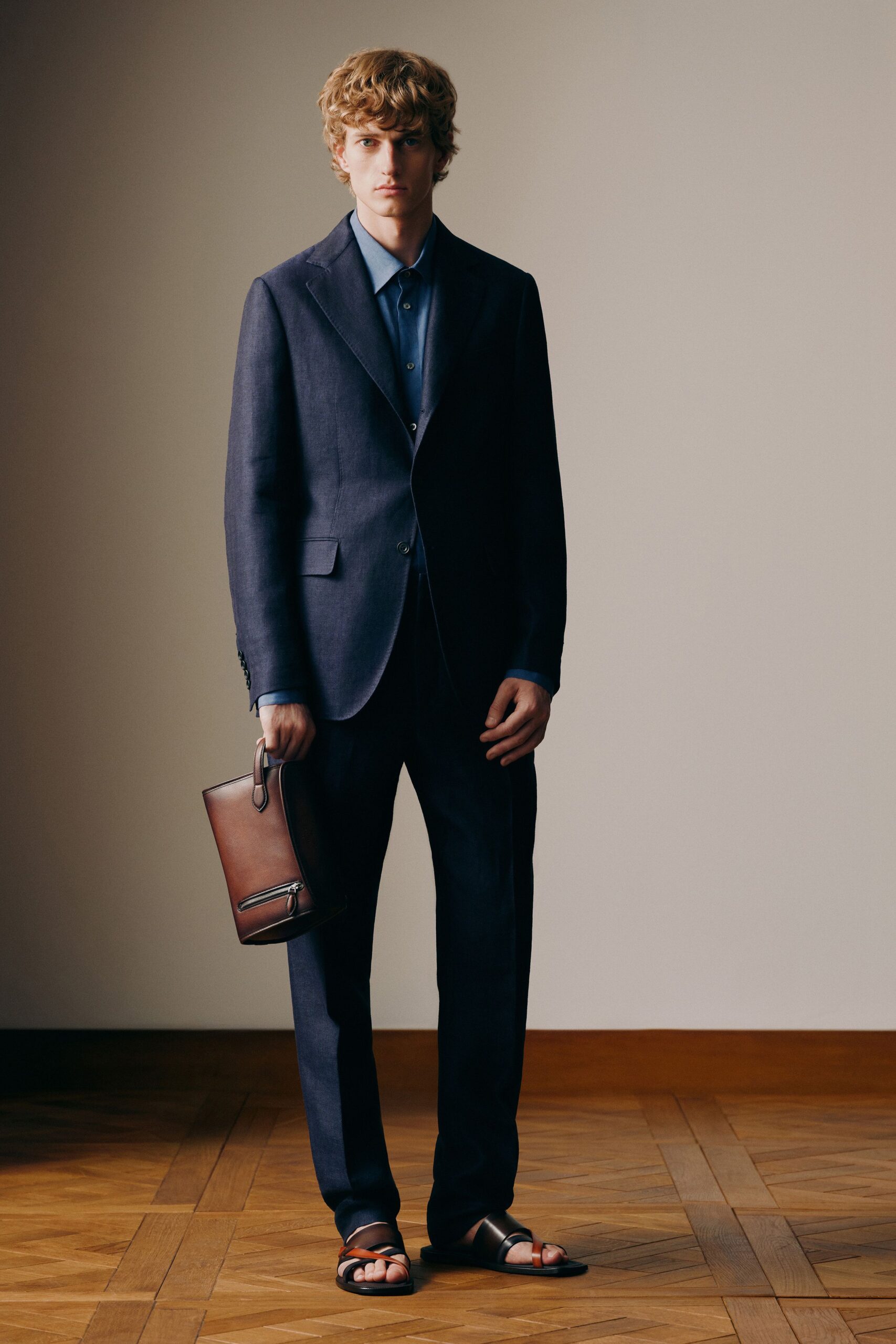 blue tailored suit with brown accessories