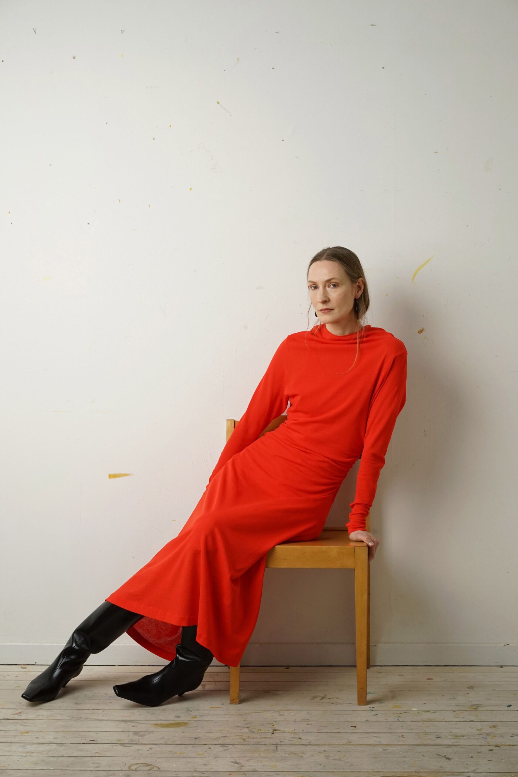 red fitted midi dress with black boots