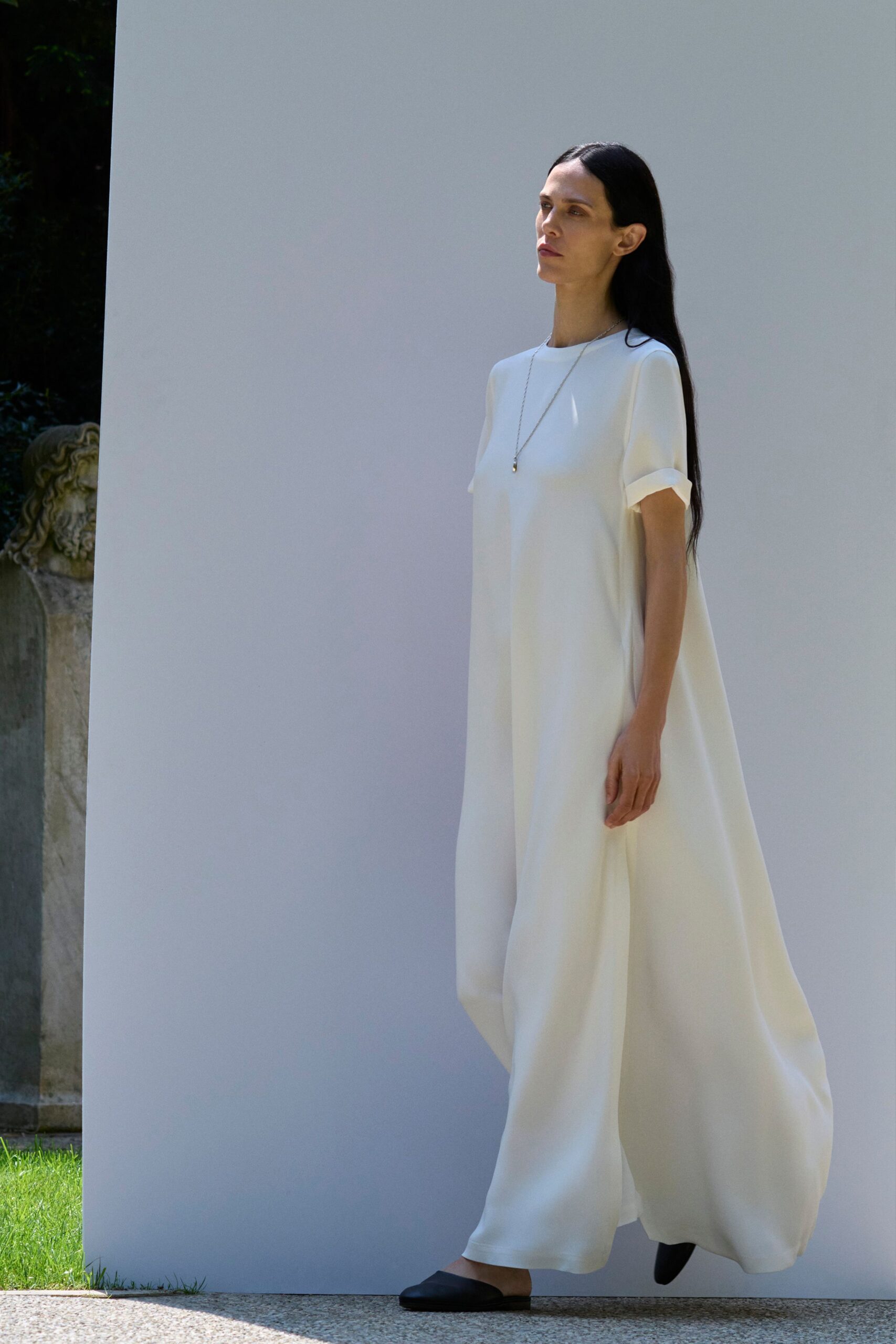 white flowing maxi dress with black shoes