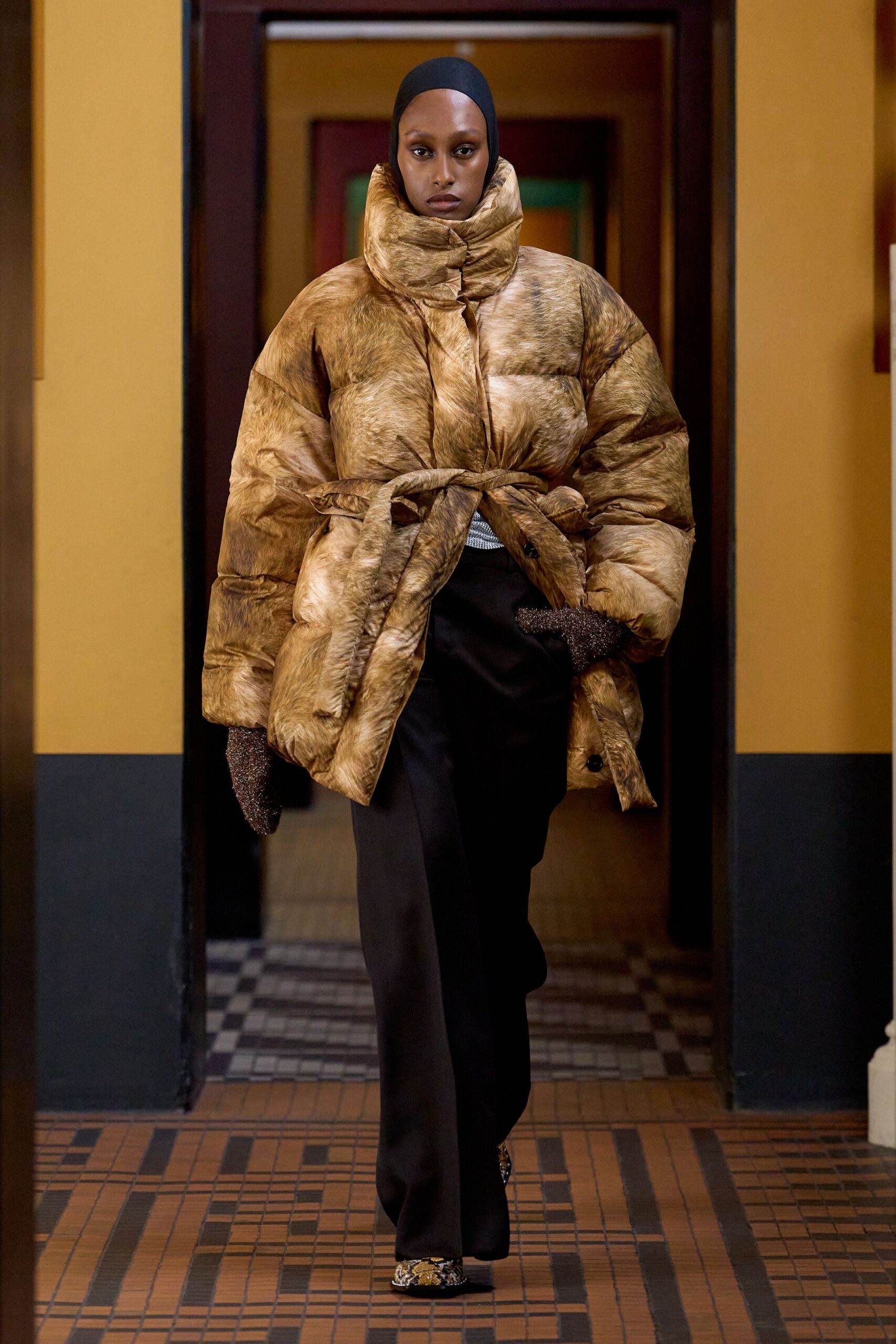 brown faux-fur coat with black pants