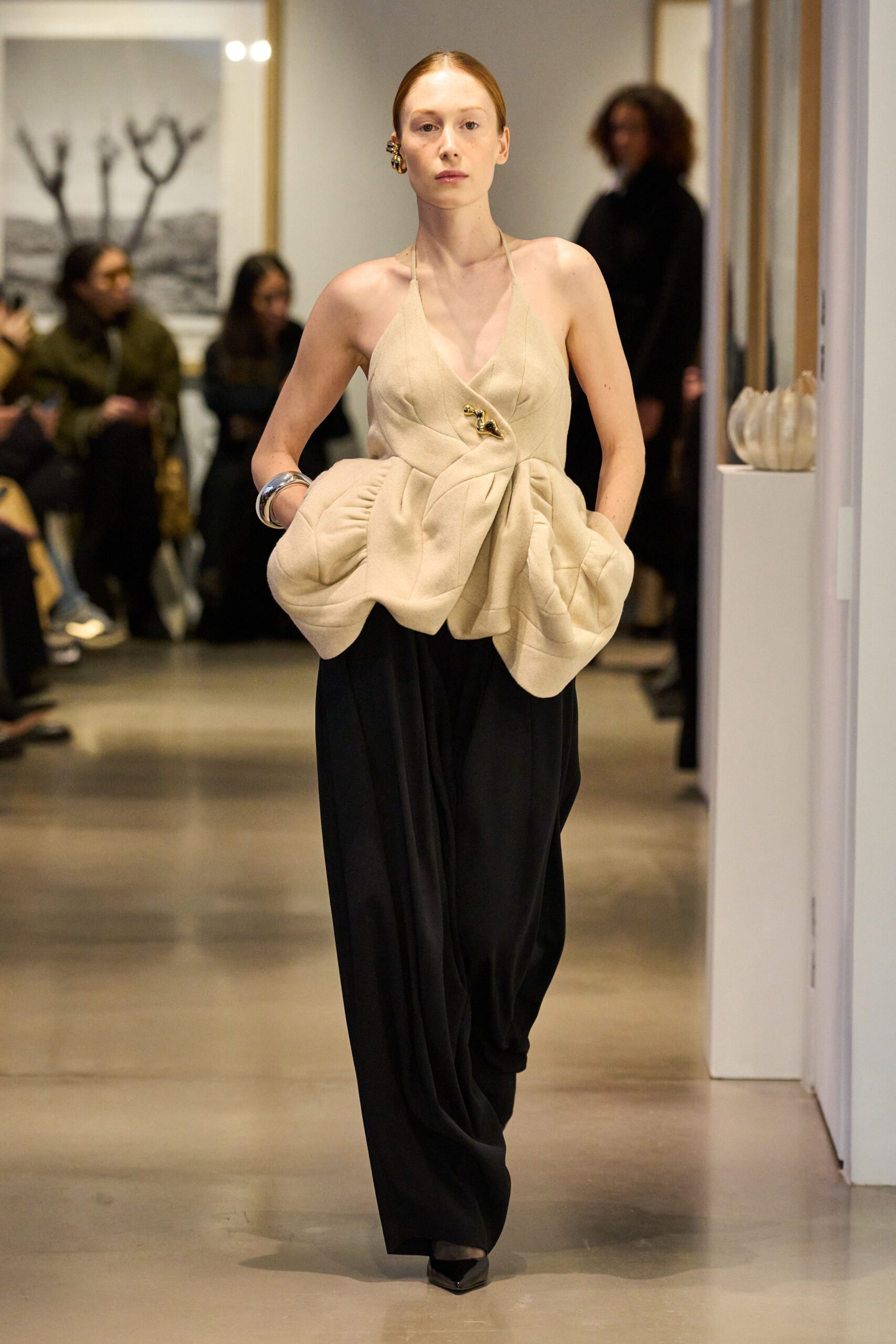 beige pleated top with black pants