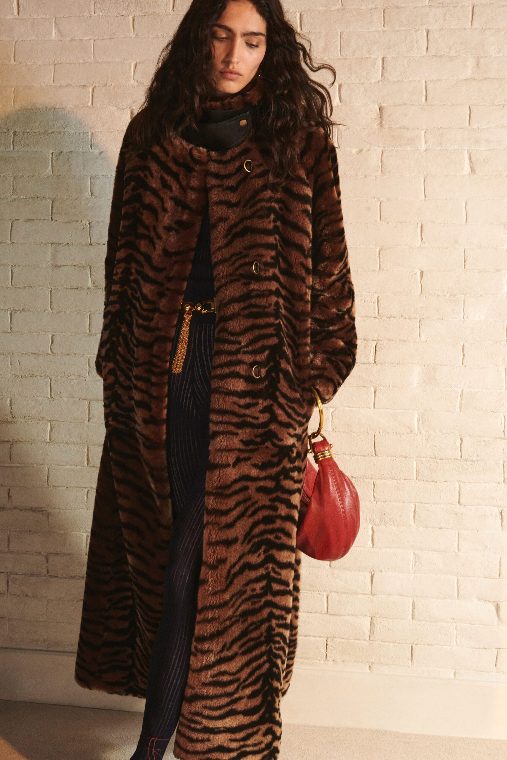 brown faux-fur coat with striped dress
