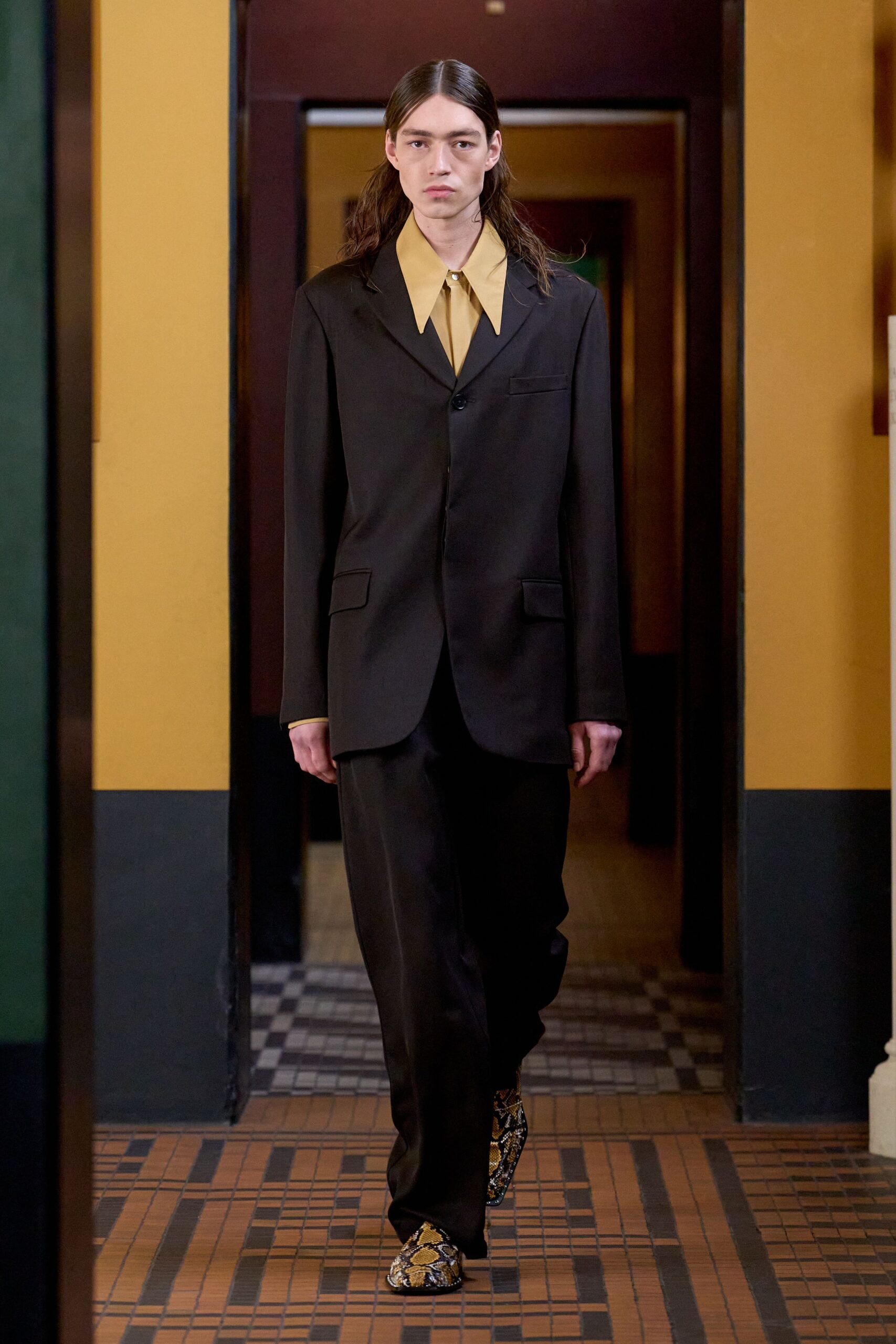 black tailored suit with yellow shirt