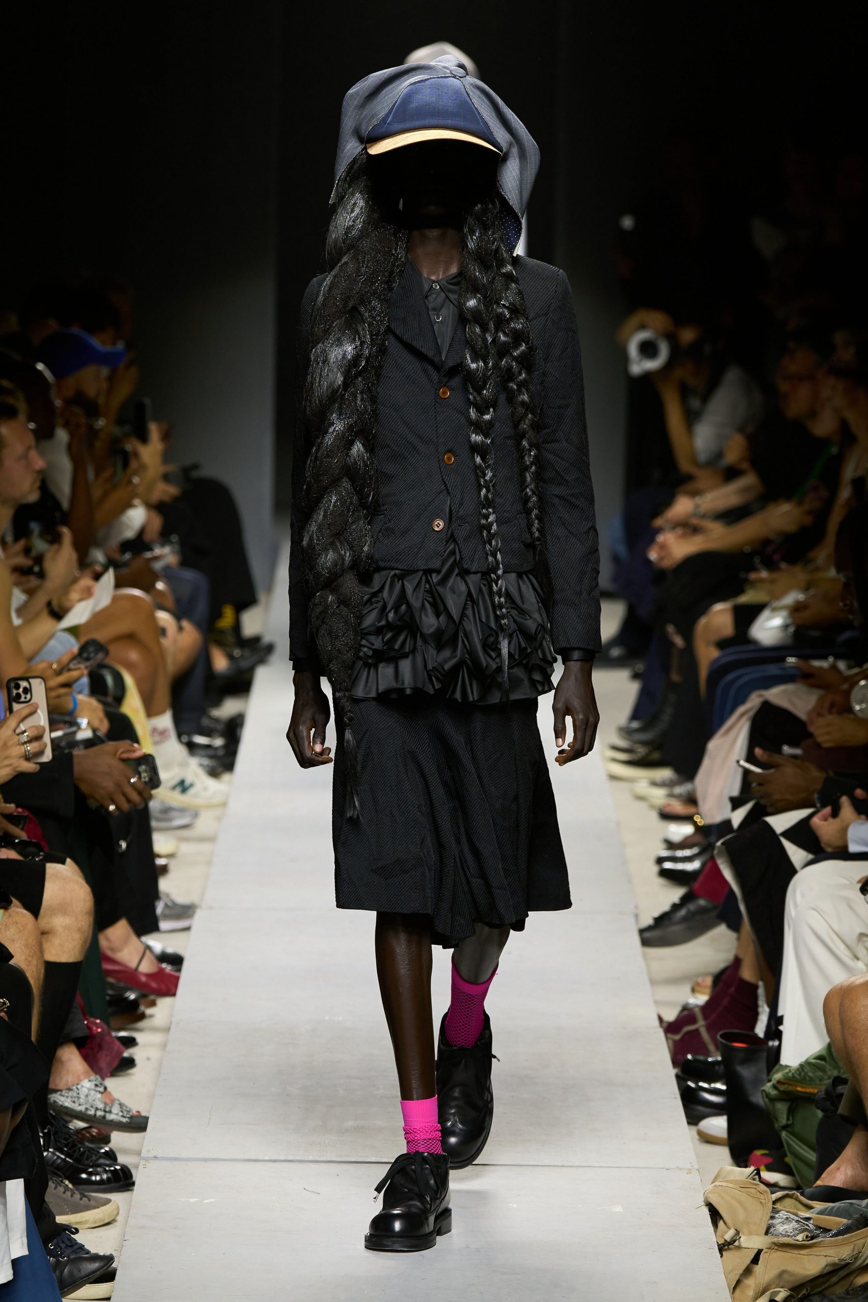 black structured jacket with pleated skirt