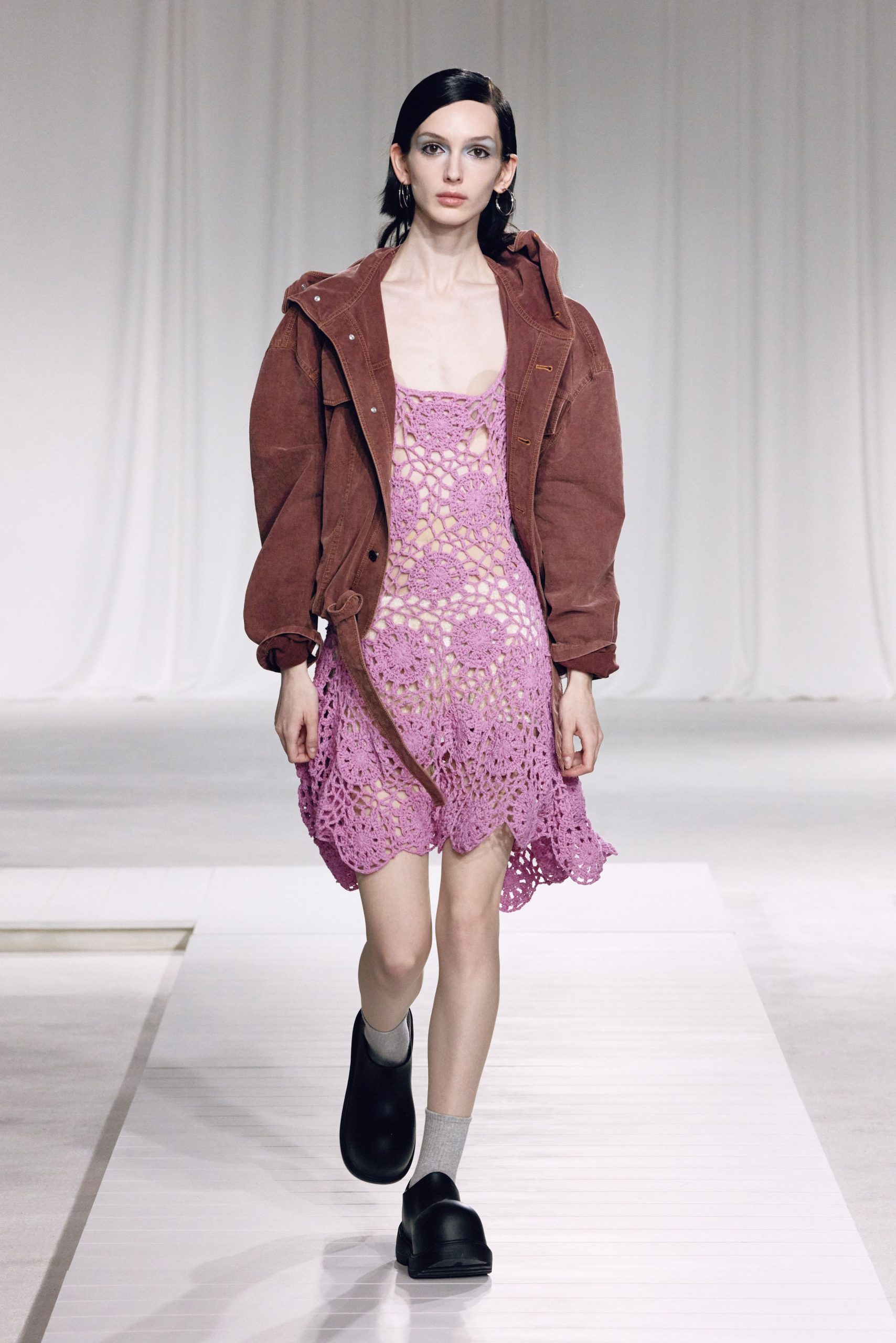 pink crochet mini dress with brown jacket