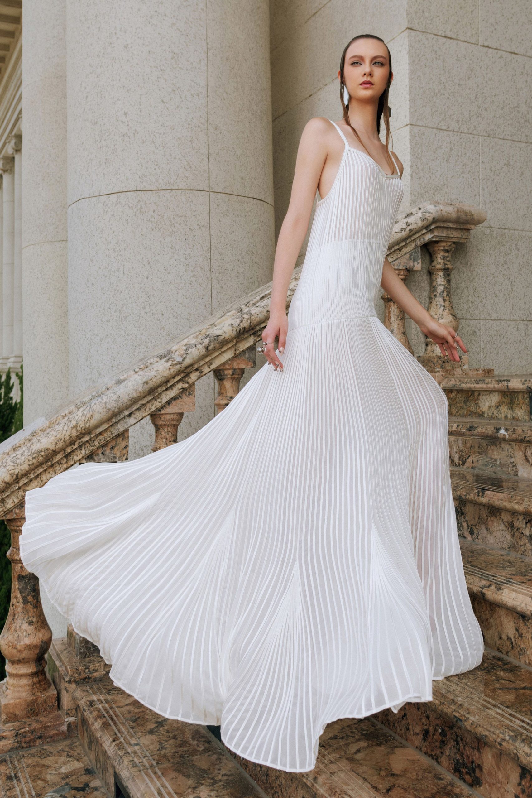 white pleated sleeveless gown