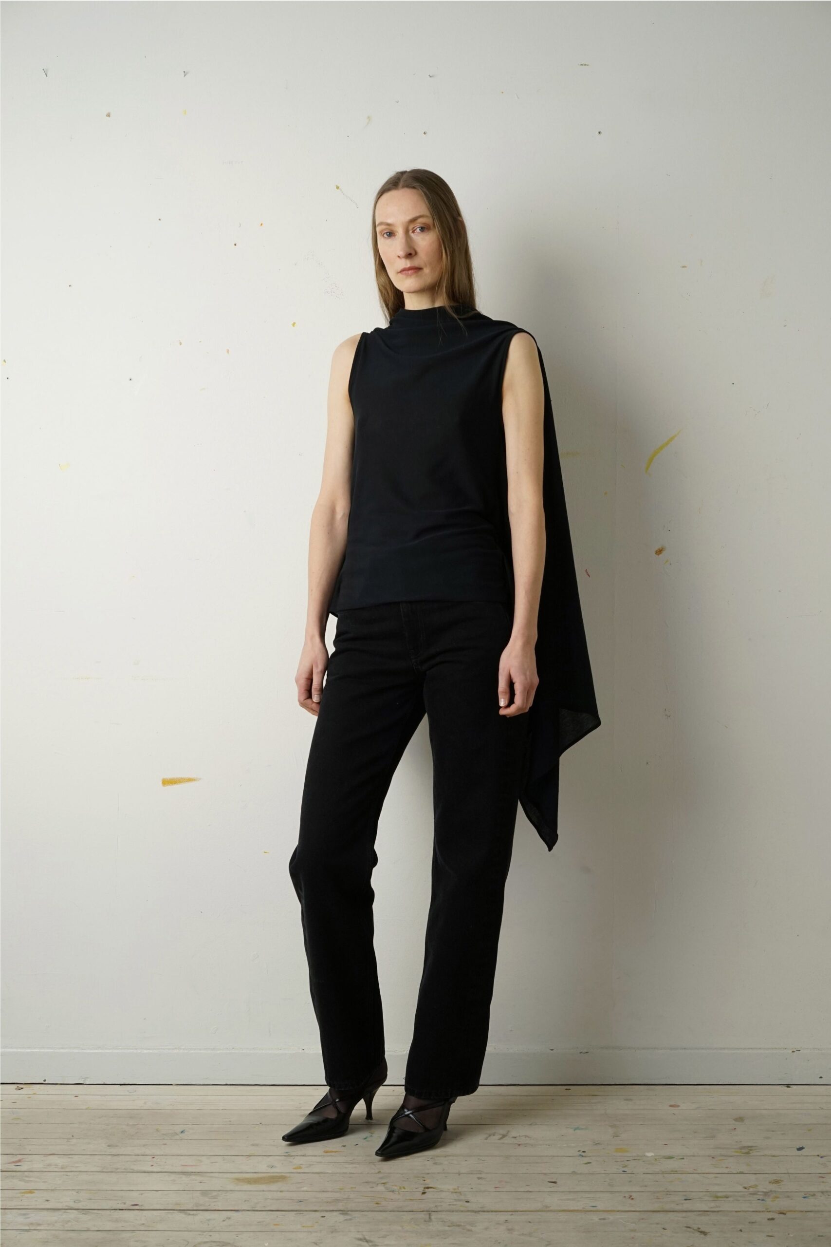 black asymmetric top with slim pants
