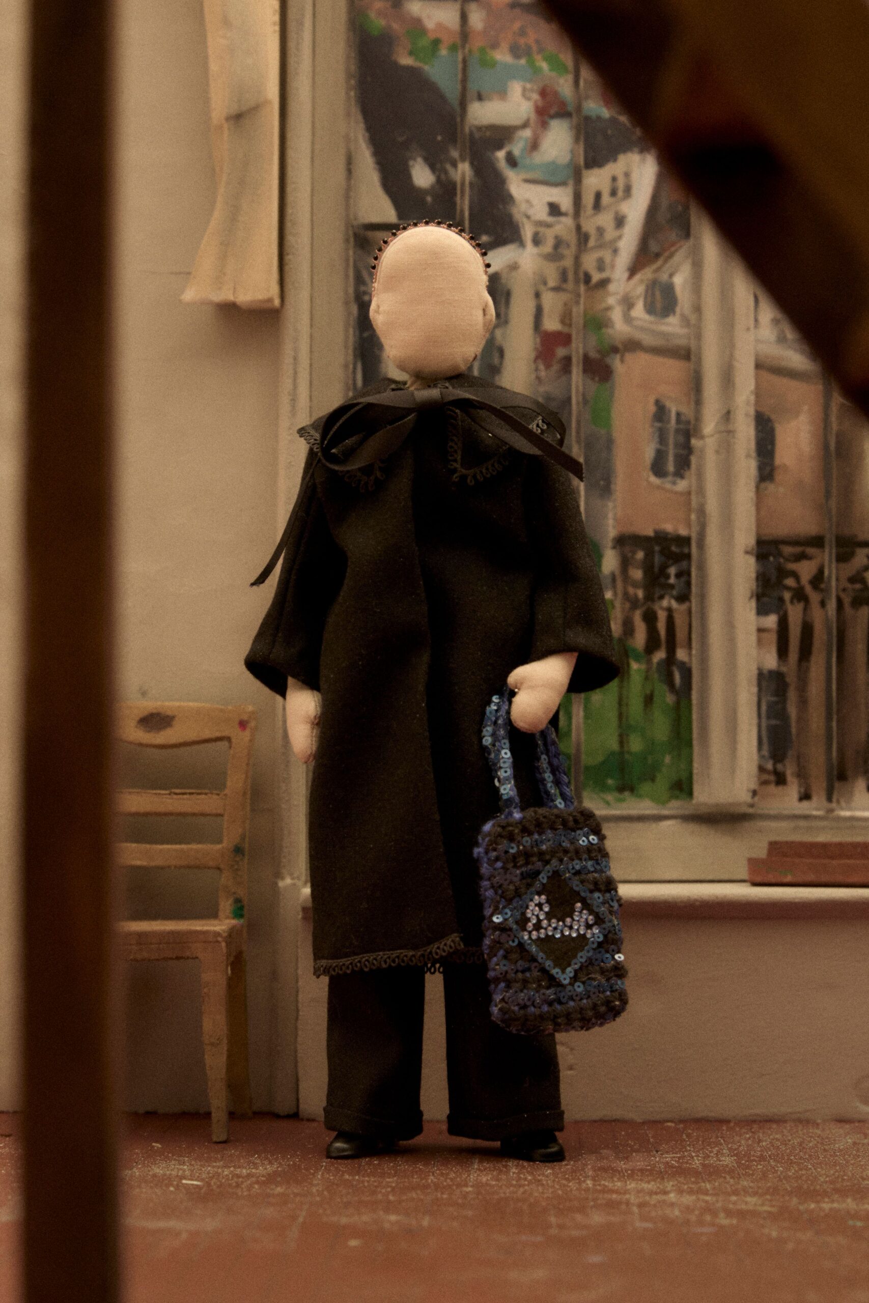 black wool coat with blue bag