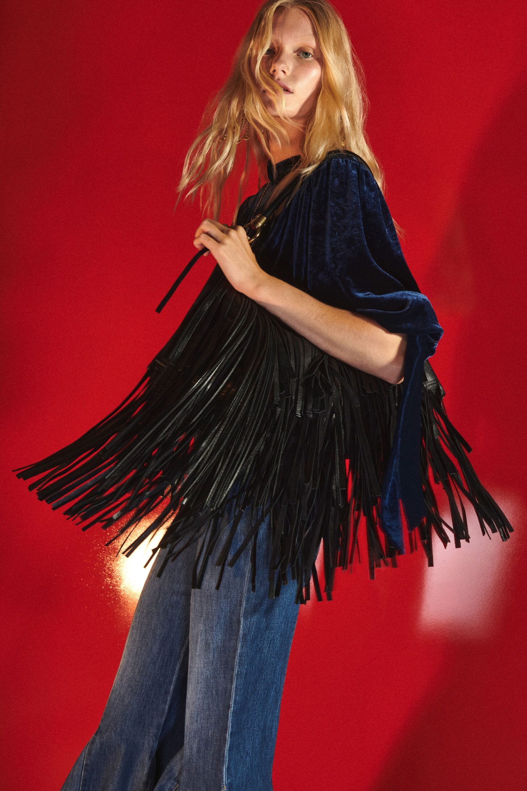 blue velvet fringed top with flared jeans