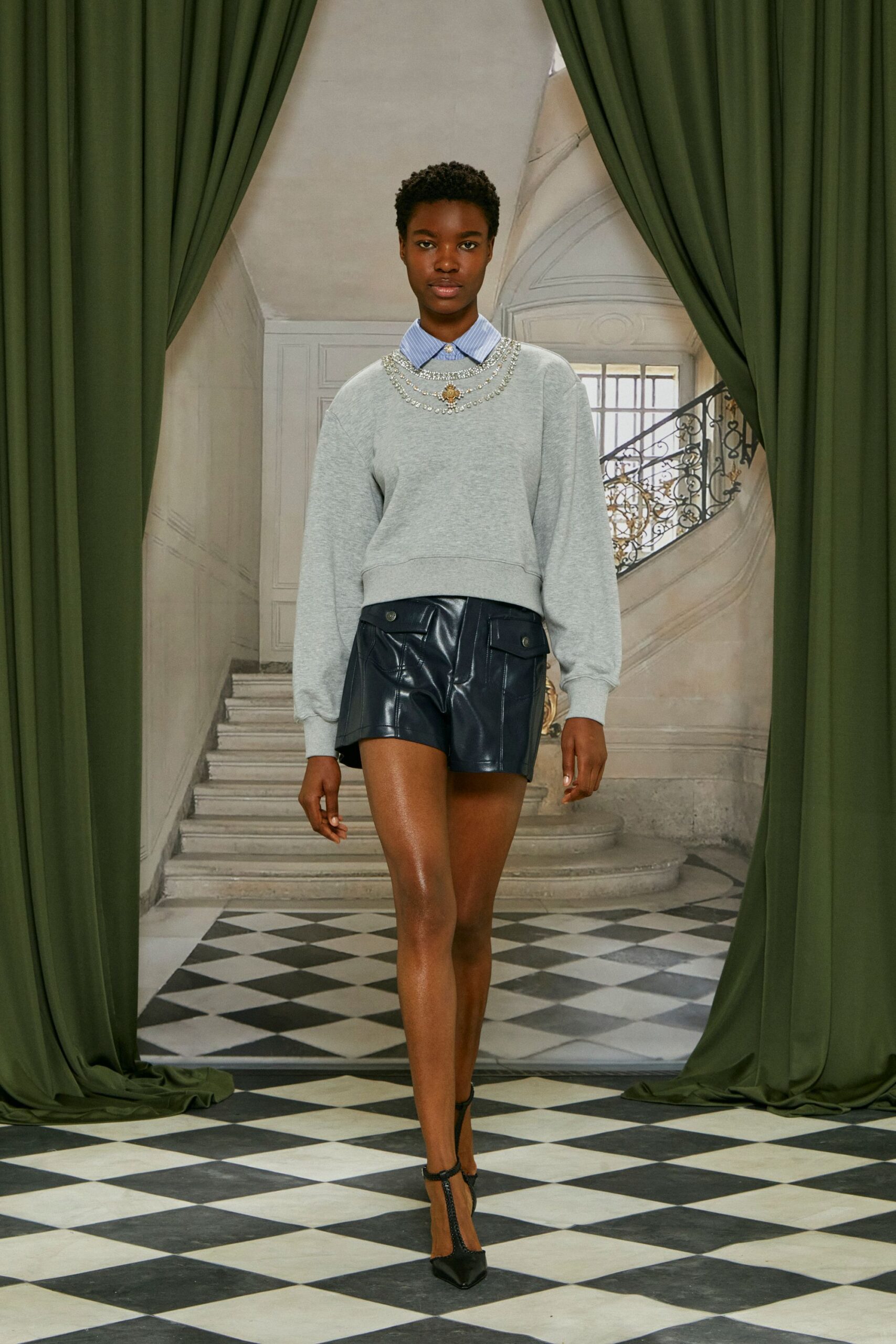 gray relaxed sweater black leather shorts