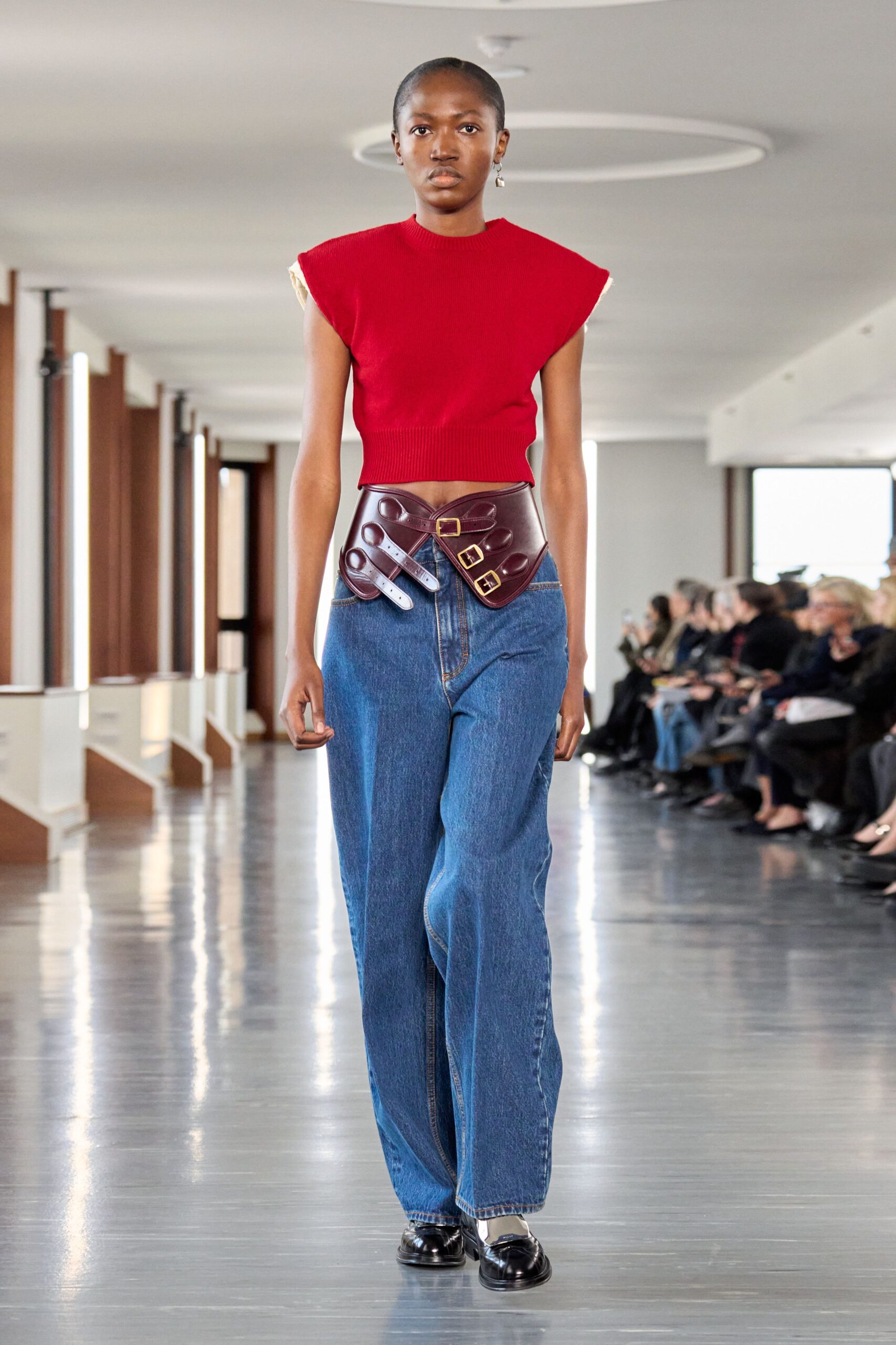red fitted top with wide-leg jeans