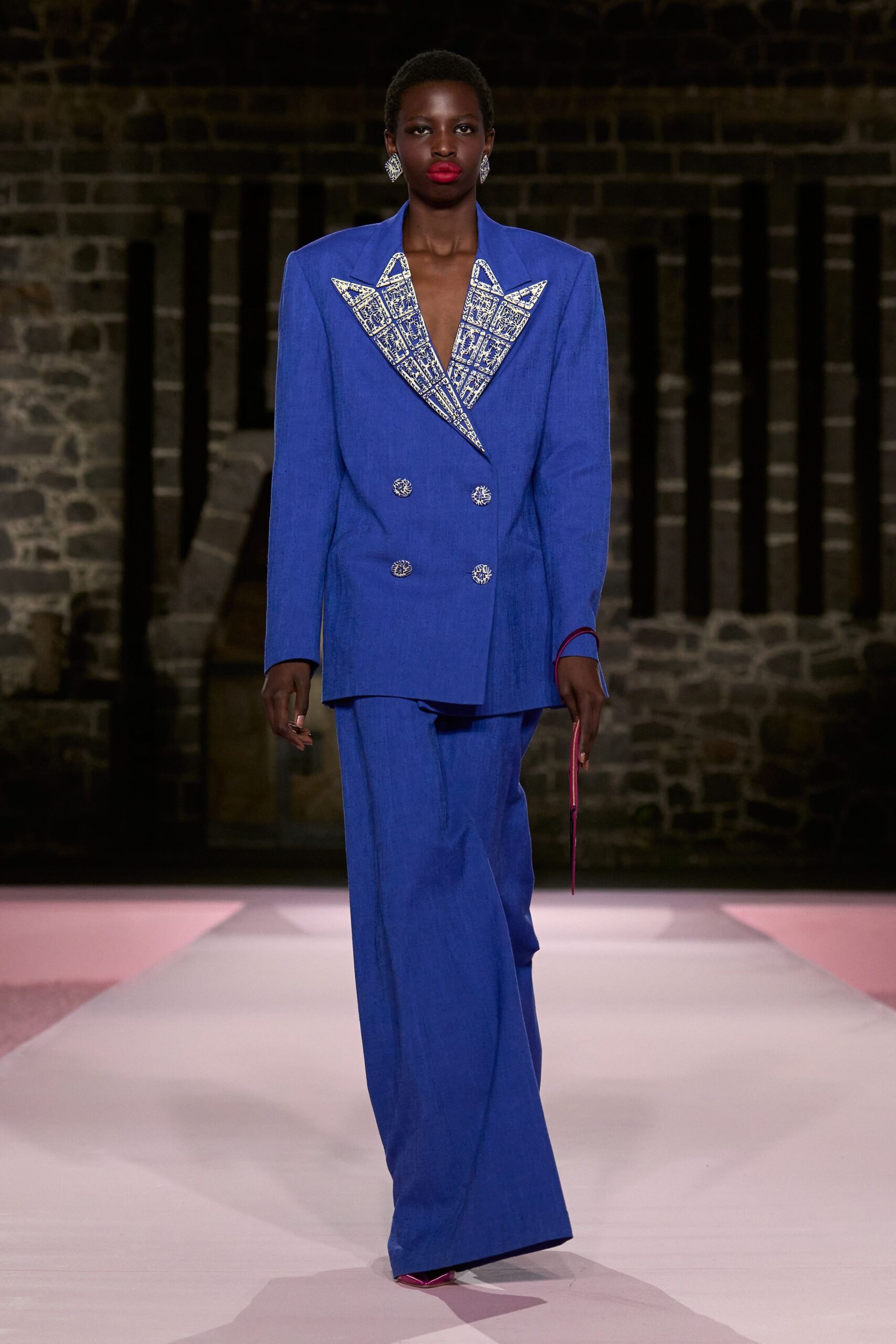 blue tailored suit with clutch