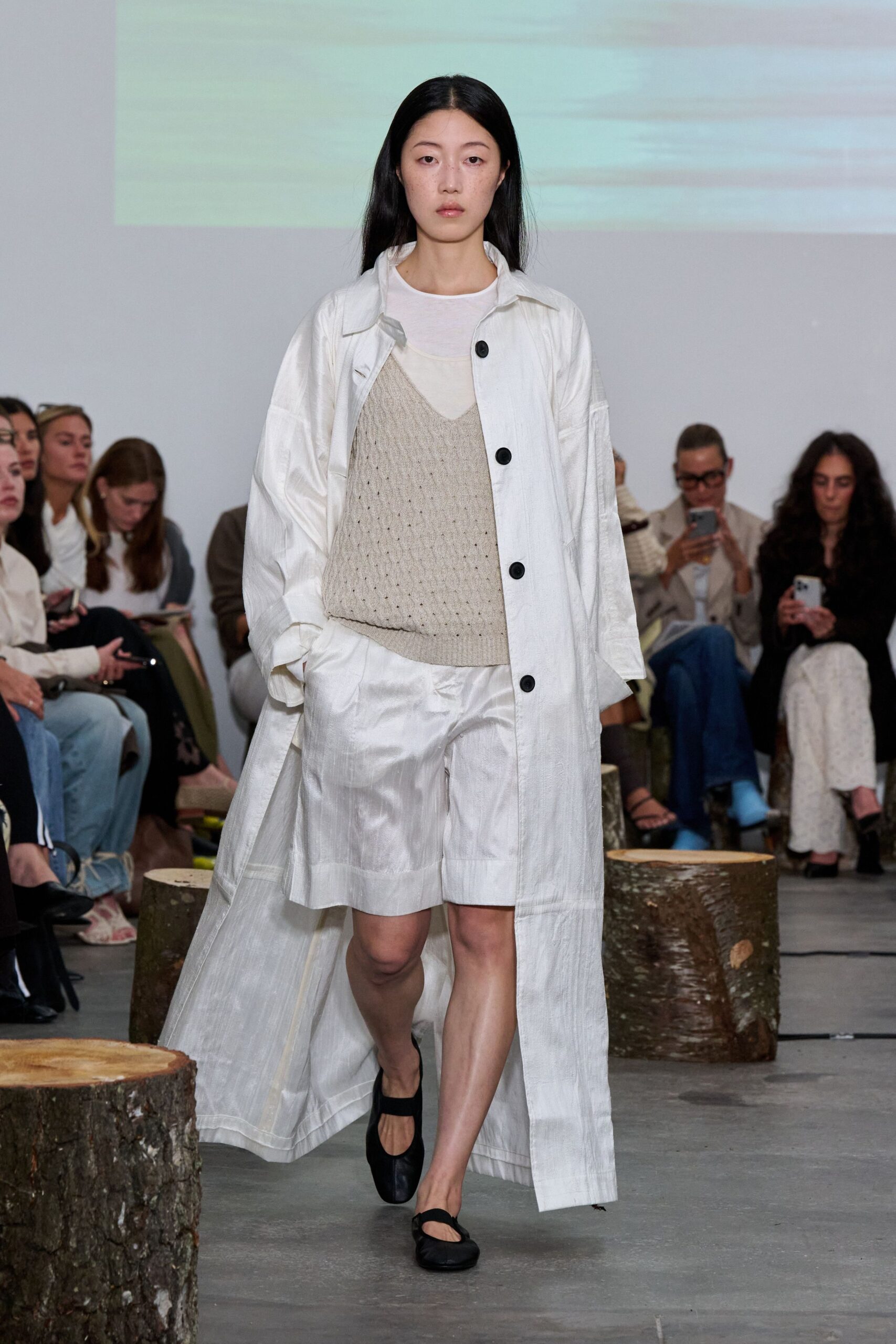 white coat beige top white shorts