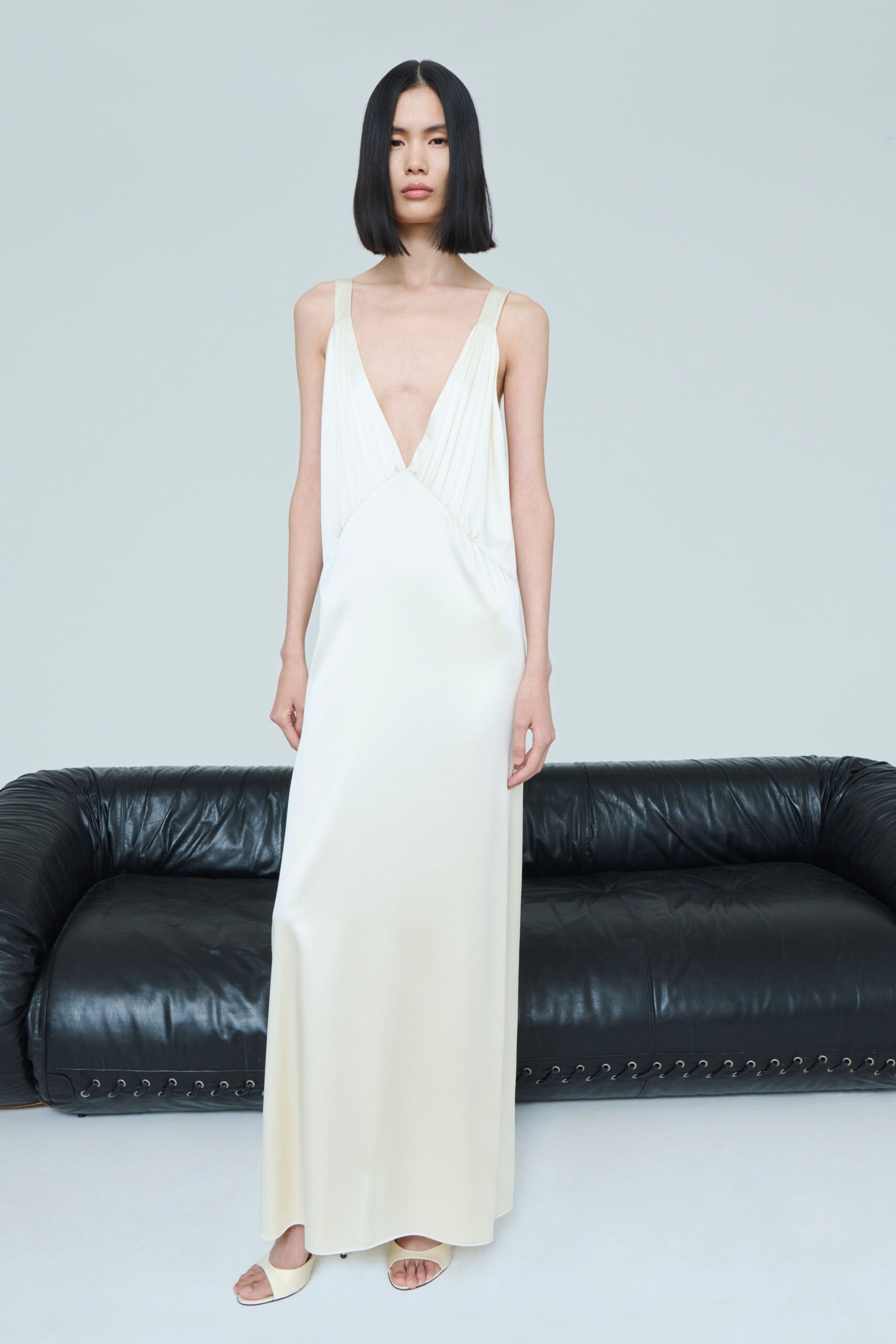 ivory silk sleeveless v-neck fitted pleated maxi gown
