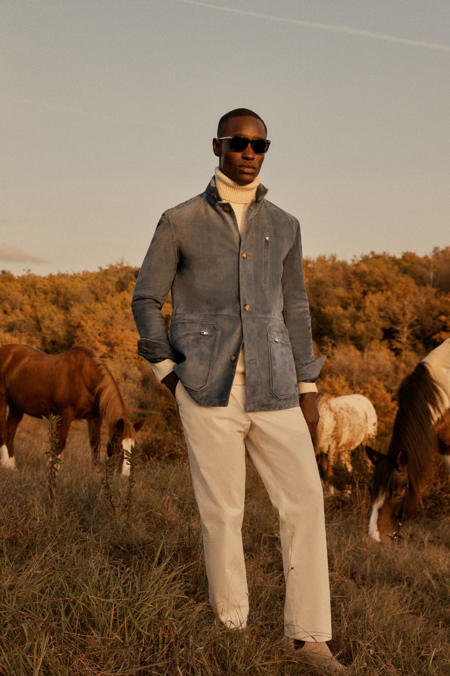 blue jacket white turtleneck beige pants