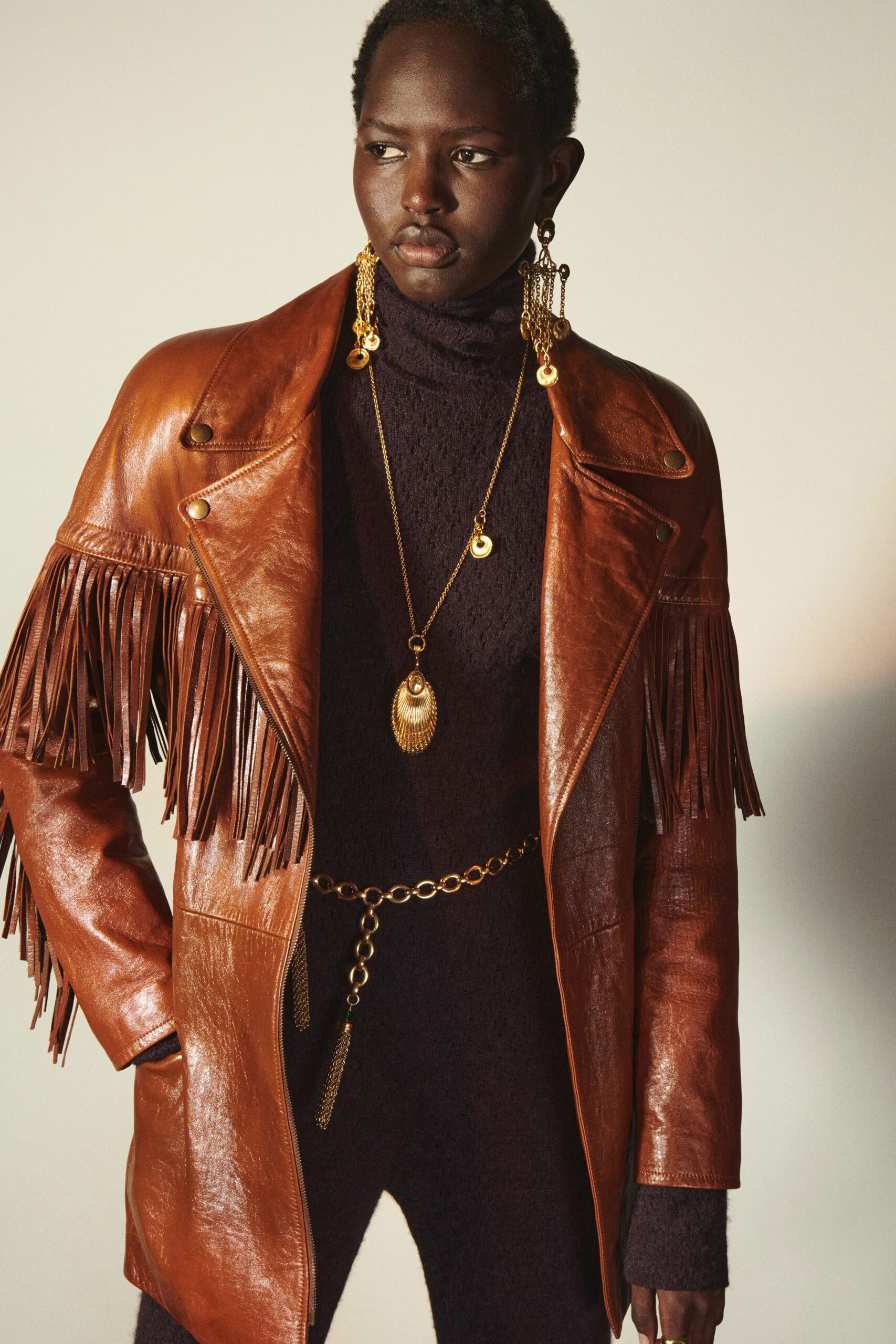 brown leather fringed jacket and purple knit dress